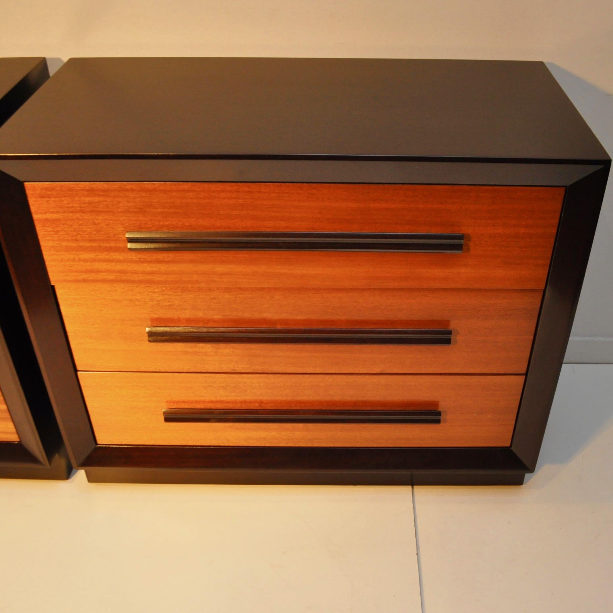 1950s era mahogany chests that have been restored to a rich, two toned finish. Horizontal drawer pulls look very much like T.H. Robsjohn-Gibbings for Widdicomb.