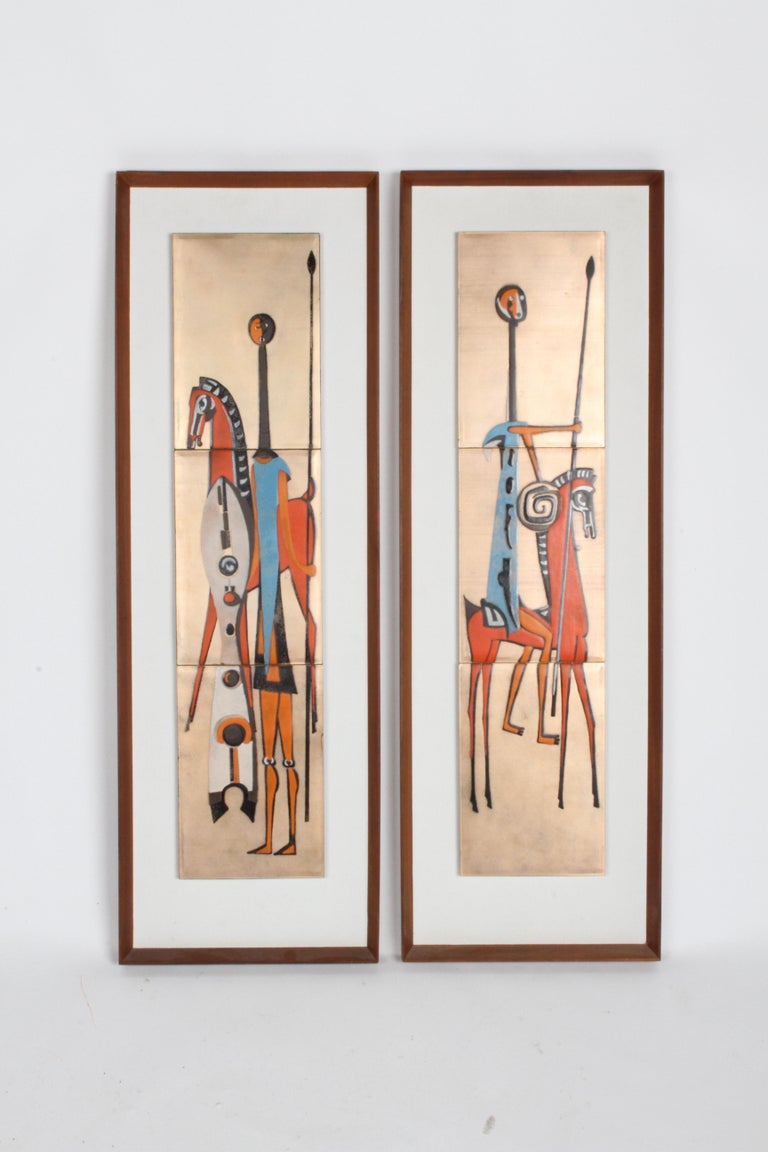 Pair of mid-century enamel on copper tiles, depicting Picasso or African style tribal warriors with horses and shields. The three tiles per plaque, float on a white background framed by original teak frames. Back of Masonite panels are marked Royal