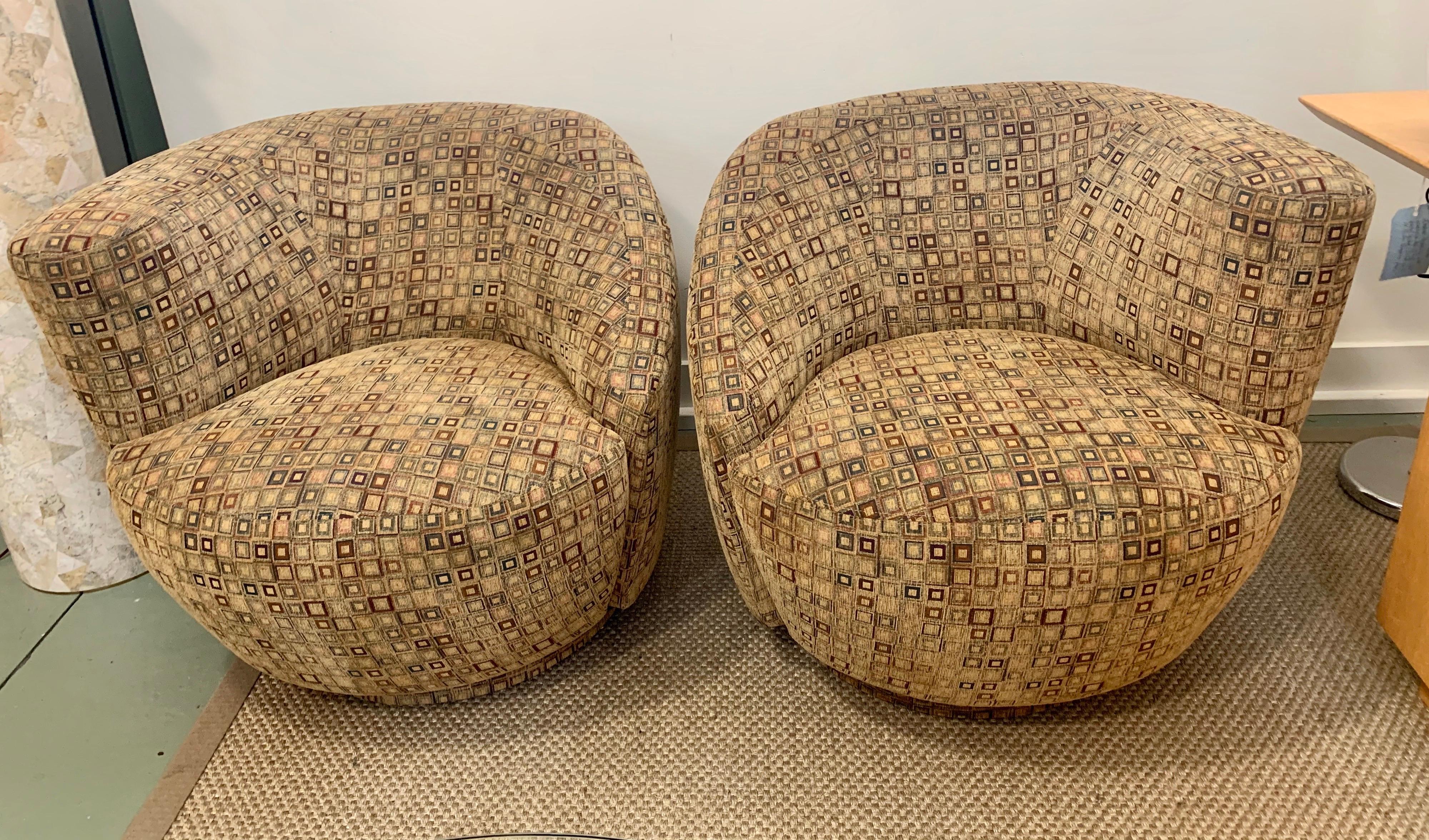 Magnificent pair of Kagan Nautilus swivel chairs. The fabric is an off beige/brown with geomtetric design and still in good condition. The ultimate in comfort and design and one of the true iconic mid century pieces today. Now, more than ever, home
