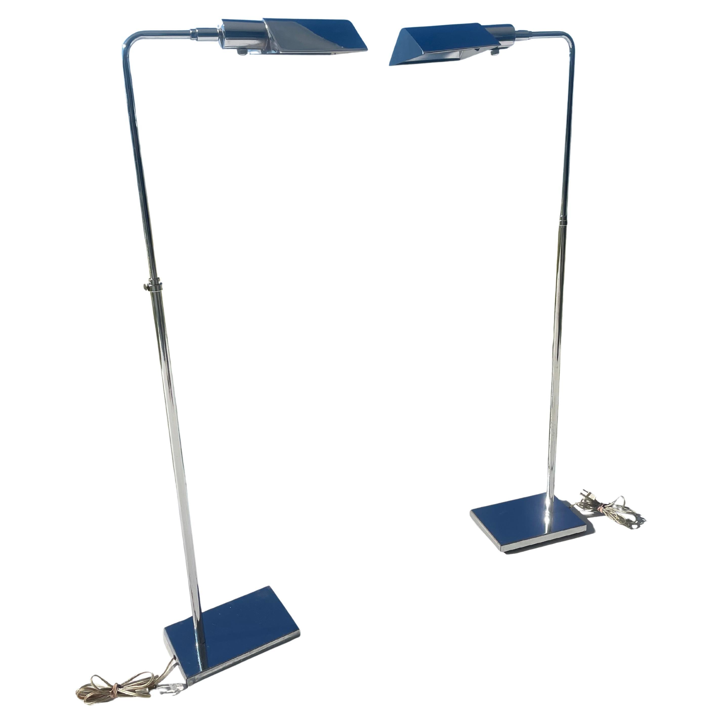 This lovely pair of 1970s chrome lamps are adjustable in height and the triangular shades adjust up a down and side to side . Very famous simple design sometimes called Pharmacy lamps . Marked OMI.