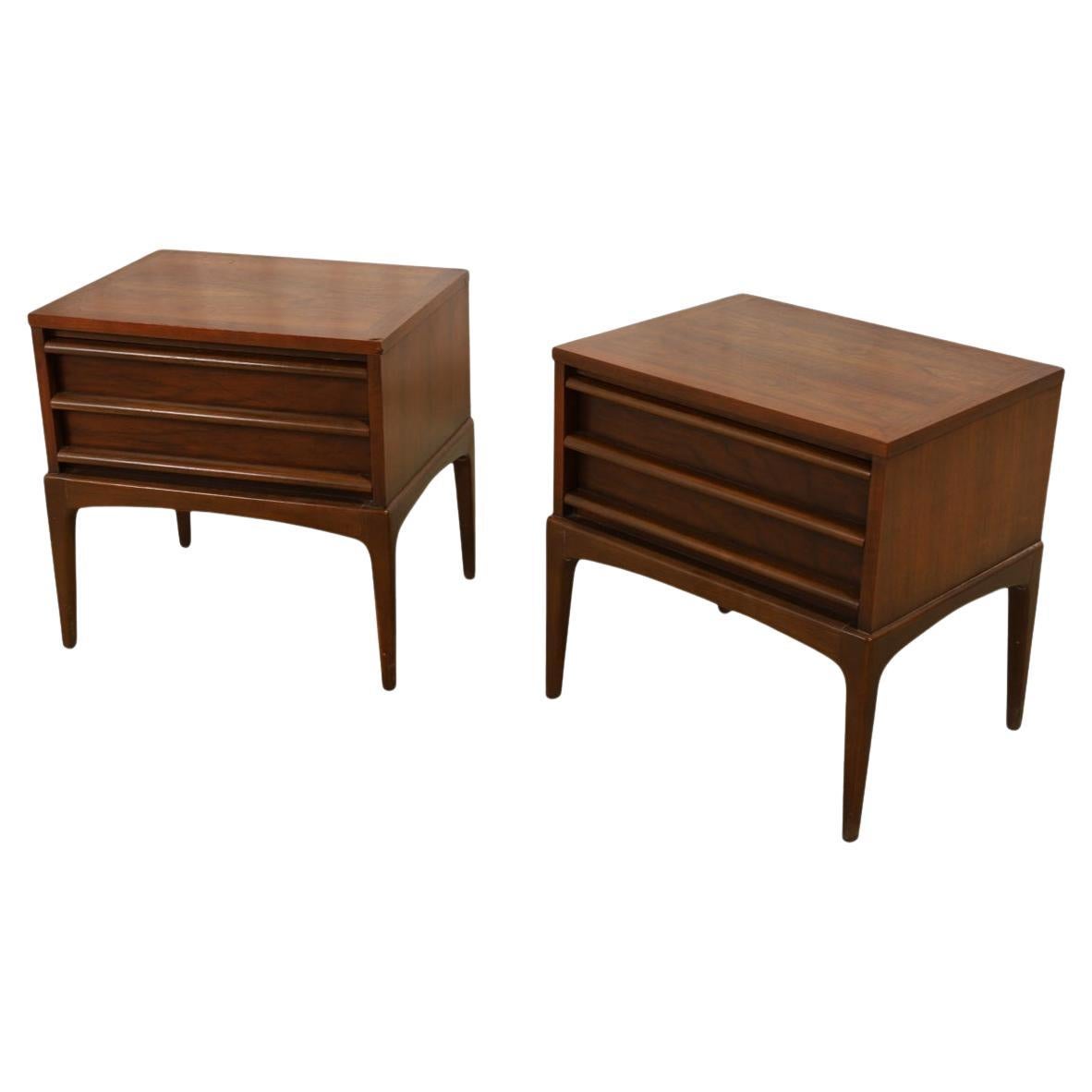 Pair Mid century rhythm Lane walnut single drawer nightstands. Designed and manufactured by Lane in Alta Vista VA. Walnut solid oak drawer construction with carved handle pulls. Very well built and beautiful pair of matching bedside or end tables or