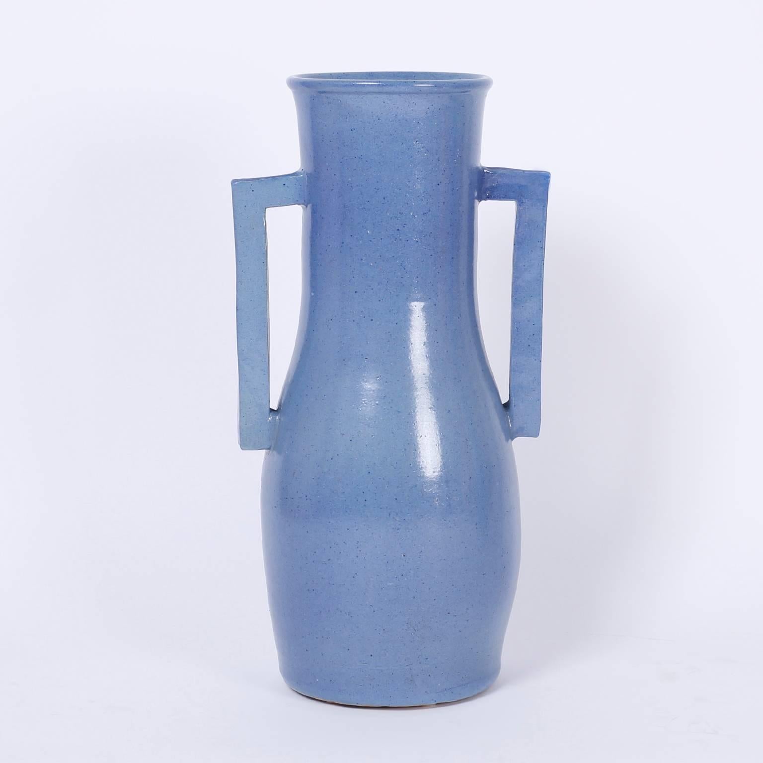 Striking pair of hand-turned terra cotta vases with an alluring
blue glaze over a bold Art Deco form.