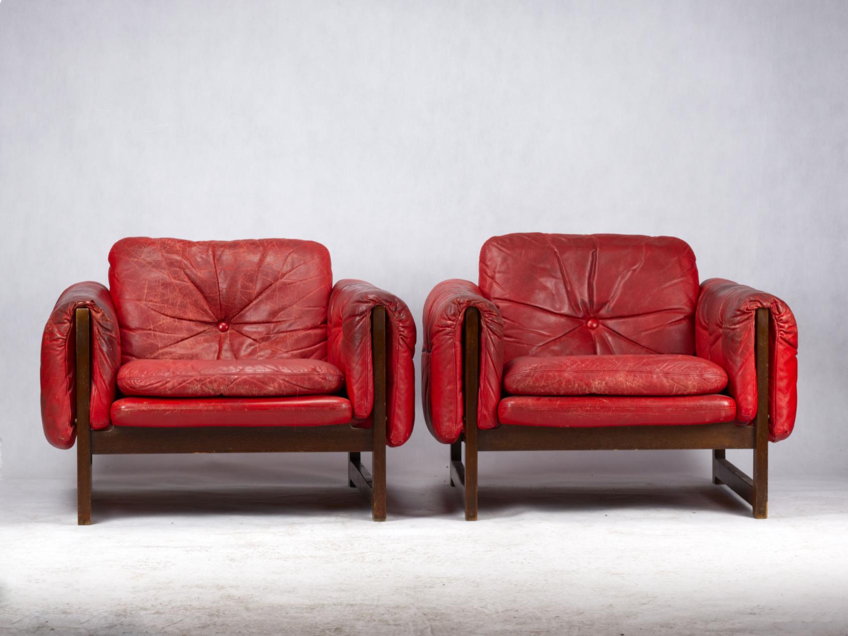A pair of red leather lounge chairs, 