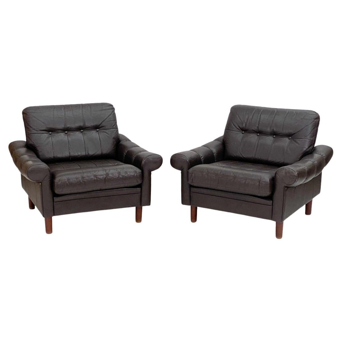 Now available, this very handsome pair of danish, leather and teak Lounge chairs. Low slung and sexy! The leather has the perfect amount of wear, and the flared, quilted arms adding just the right amount of style. The cylindrical teak legs are