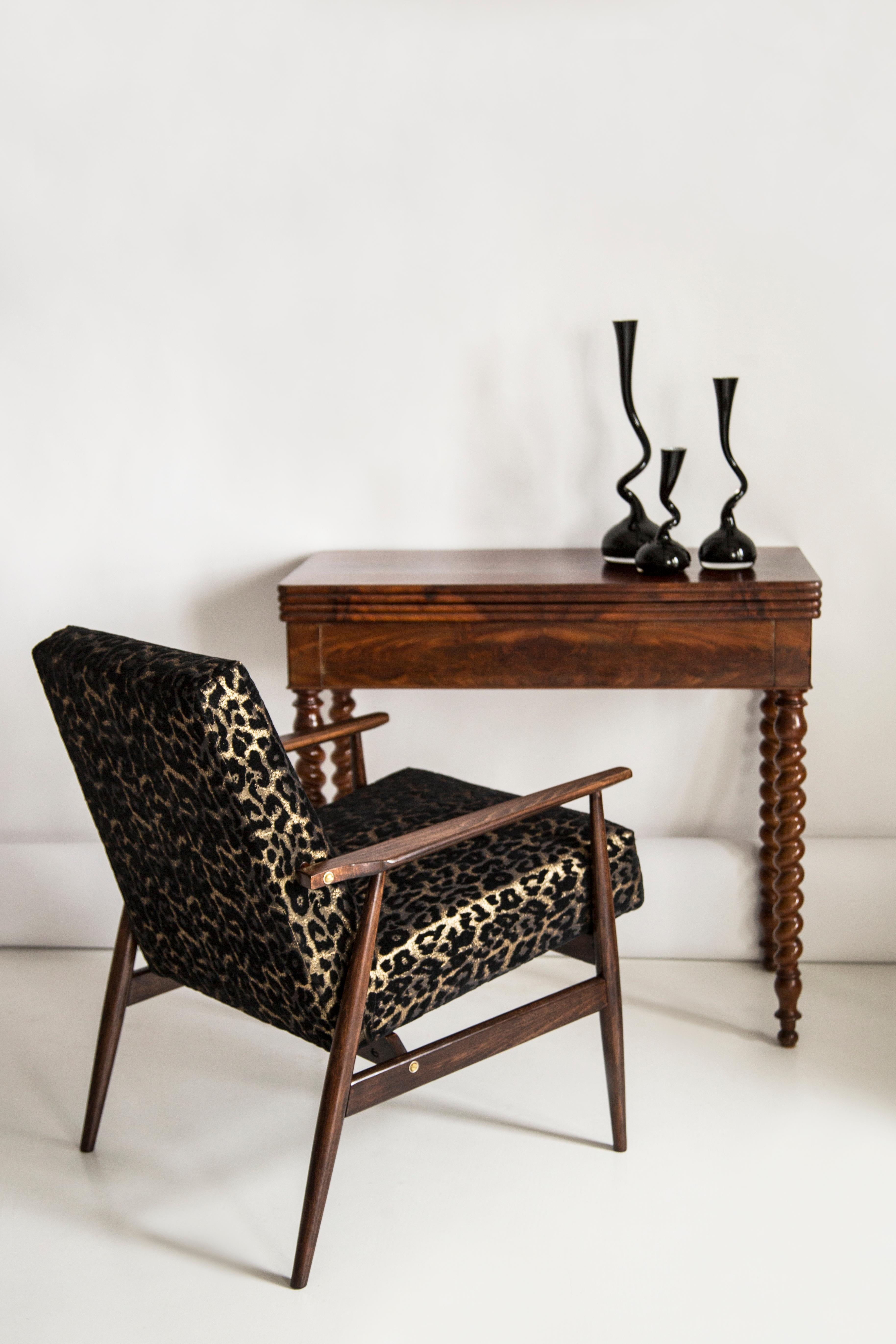 A beautiful, restored armchairs designed by Henryk Lis. Furniture after full carpentry and upholstery renovation. The fabric, which is covered with a backrest and a seat, is a high-quality Italian velvet upholstery printed in leopard pattern. The