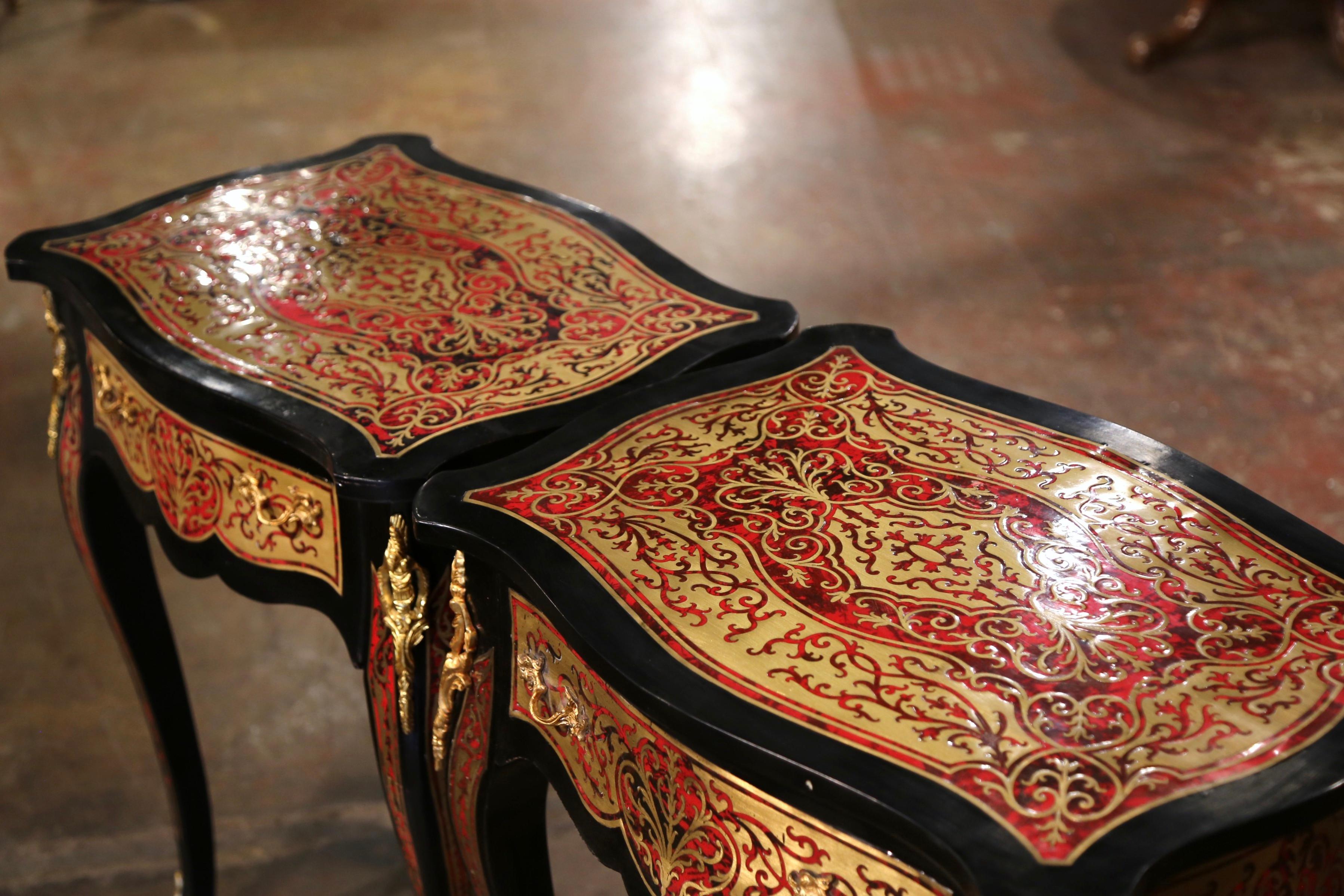 Decorate a living room or den with this elegant pair of antique side tables. Crafted in France, circa 1950 and rectangular in shape with bombe sides, each table stands on cabriole legs embellished with bronze dore mounts at the shoulder, and ending