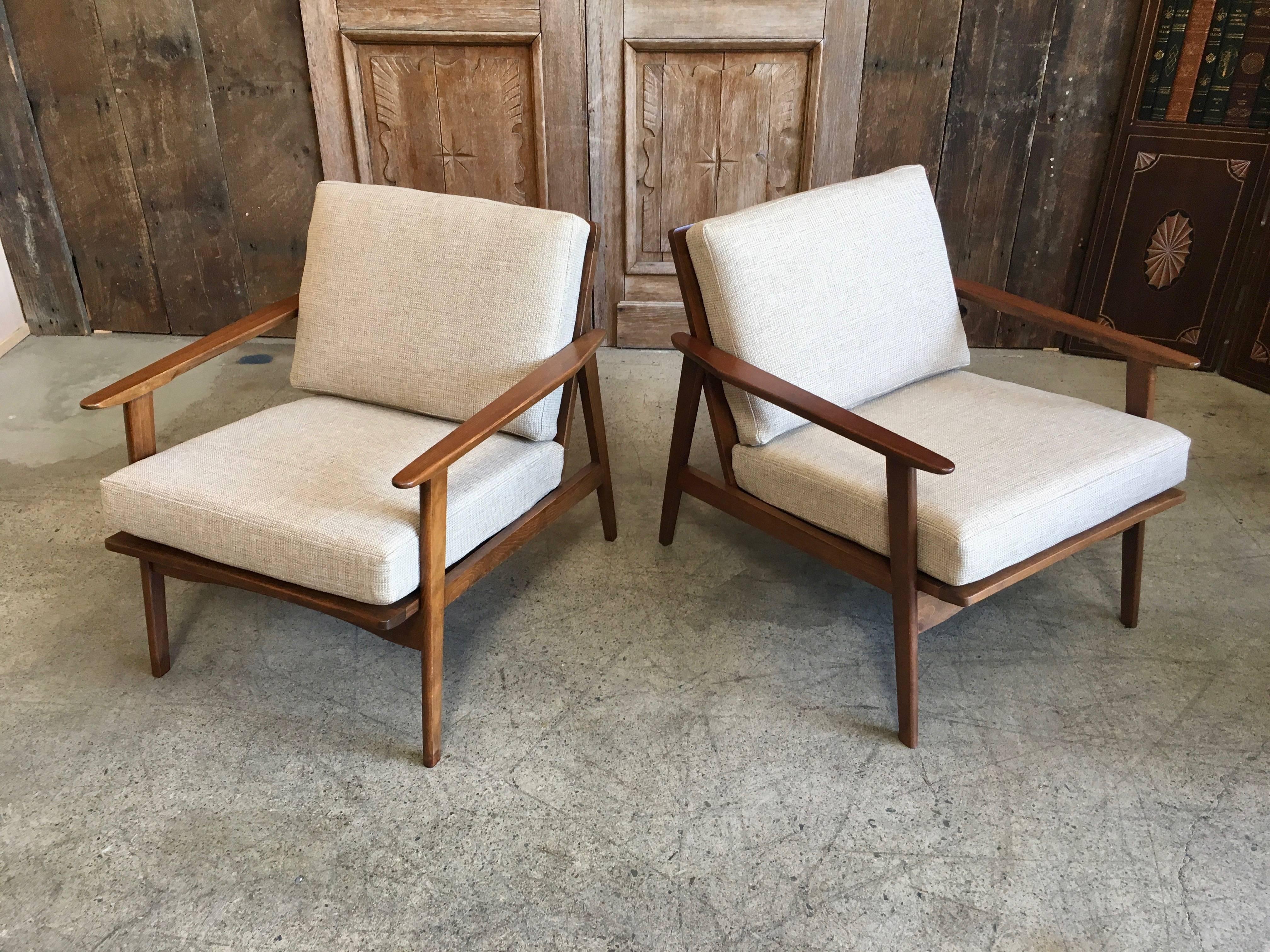 Angular walnut stained hardwood chairs with new fabric and foam.