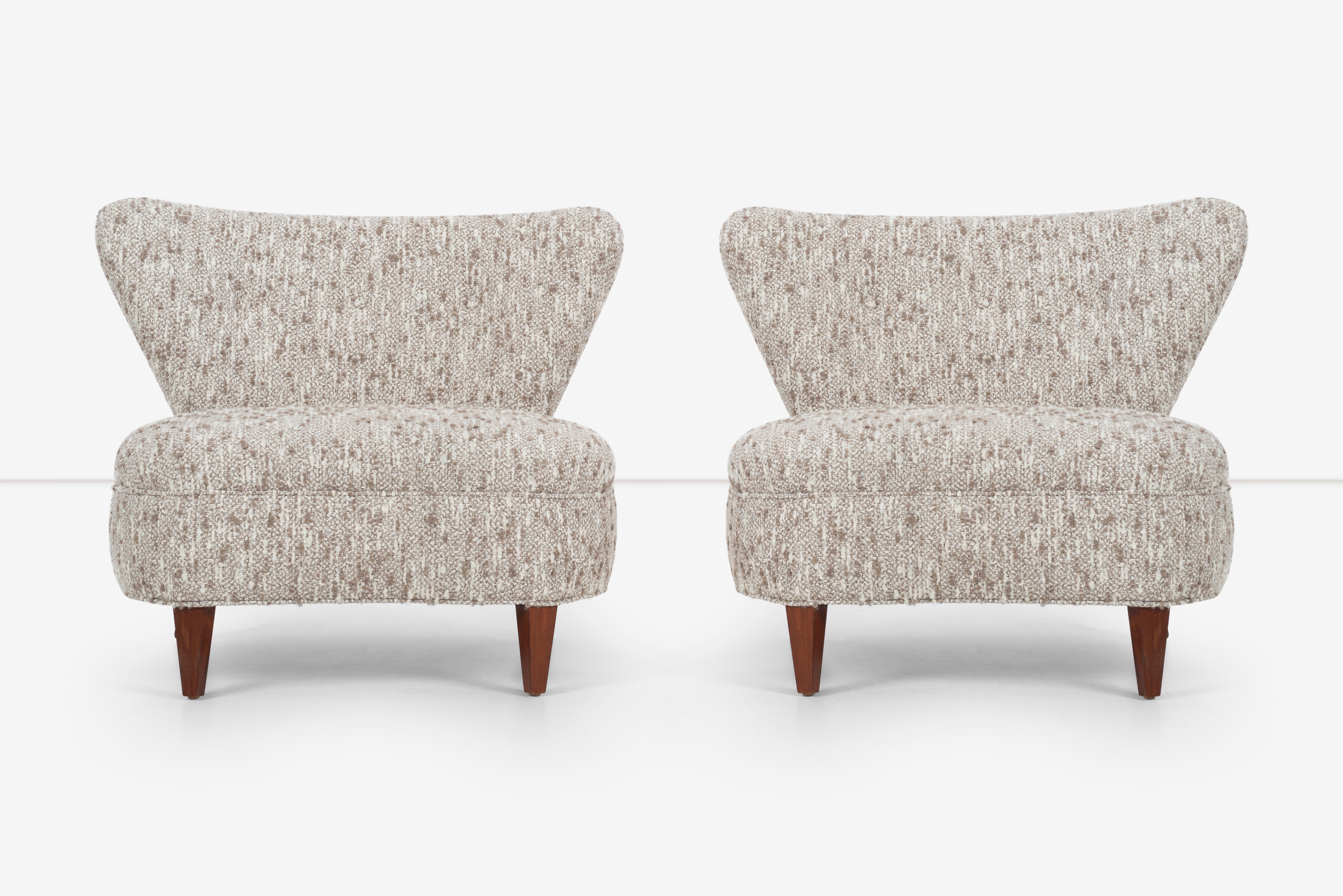 This pair of winged slipper chairs are a sophisticated and stylish addition to any home. The chairs' winged design provides a comfortable and supportive seat, while the boucle upholstery adds a touch of luxury and texture to the design. The walnut