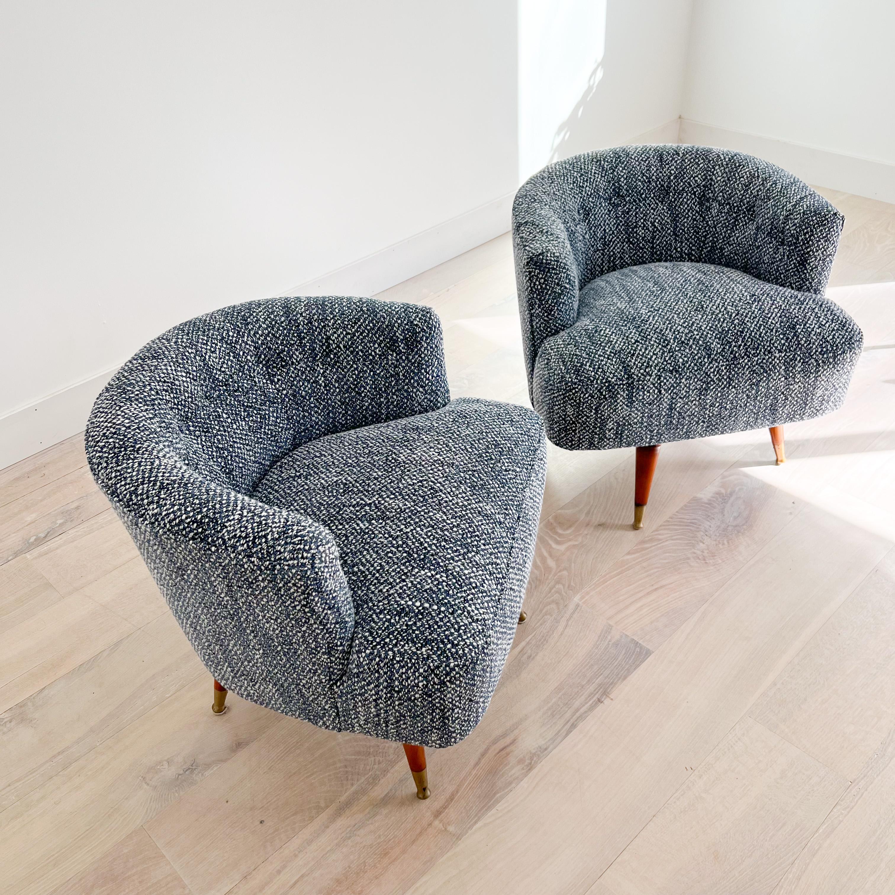 Pair of Mid-Century Modern low back swivel chairs with rotating wooden leg bases. New foam and soft blue/white tweed upholstery.