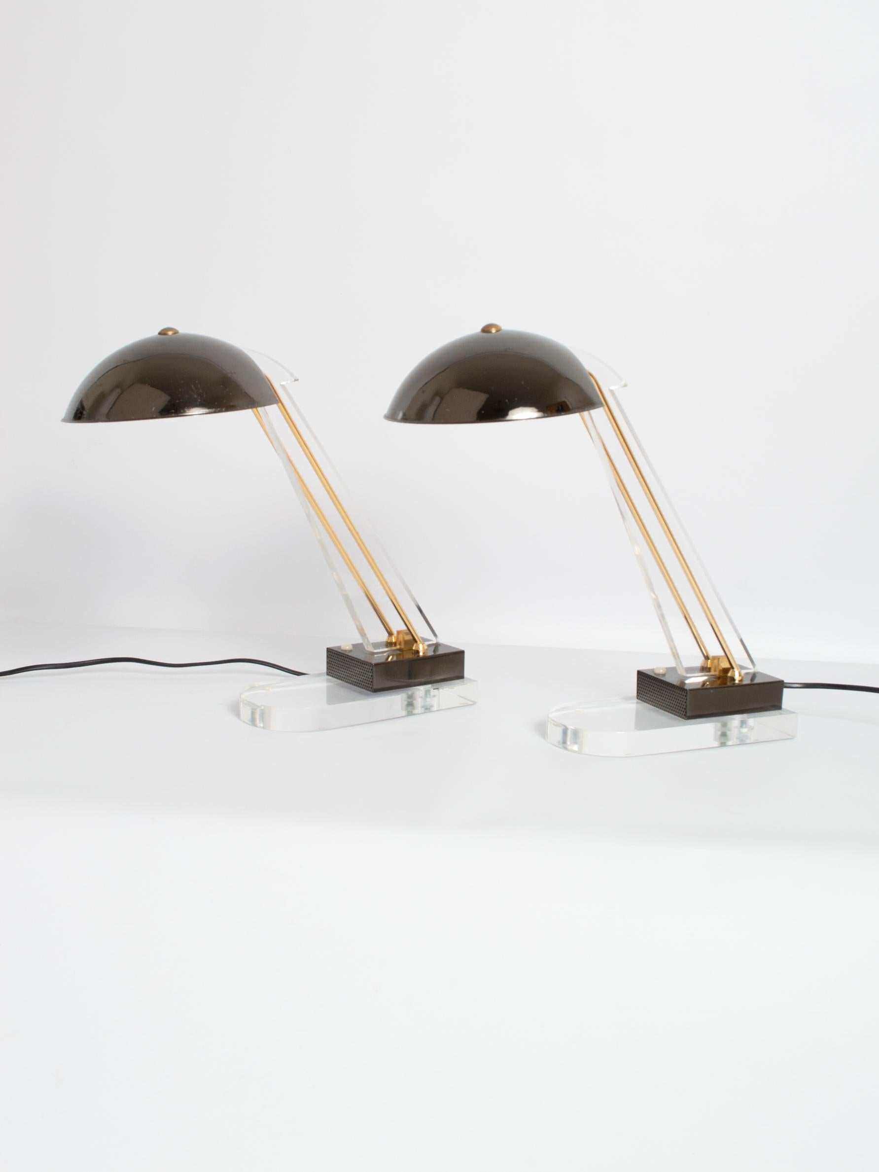 A pair of Italian midcentury Lucite and brass desk lamps by Angelo Lelii for Arredoluce, Italy, circa 1950.

In very good vintage condition, with expected signs of patination to the metalware.