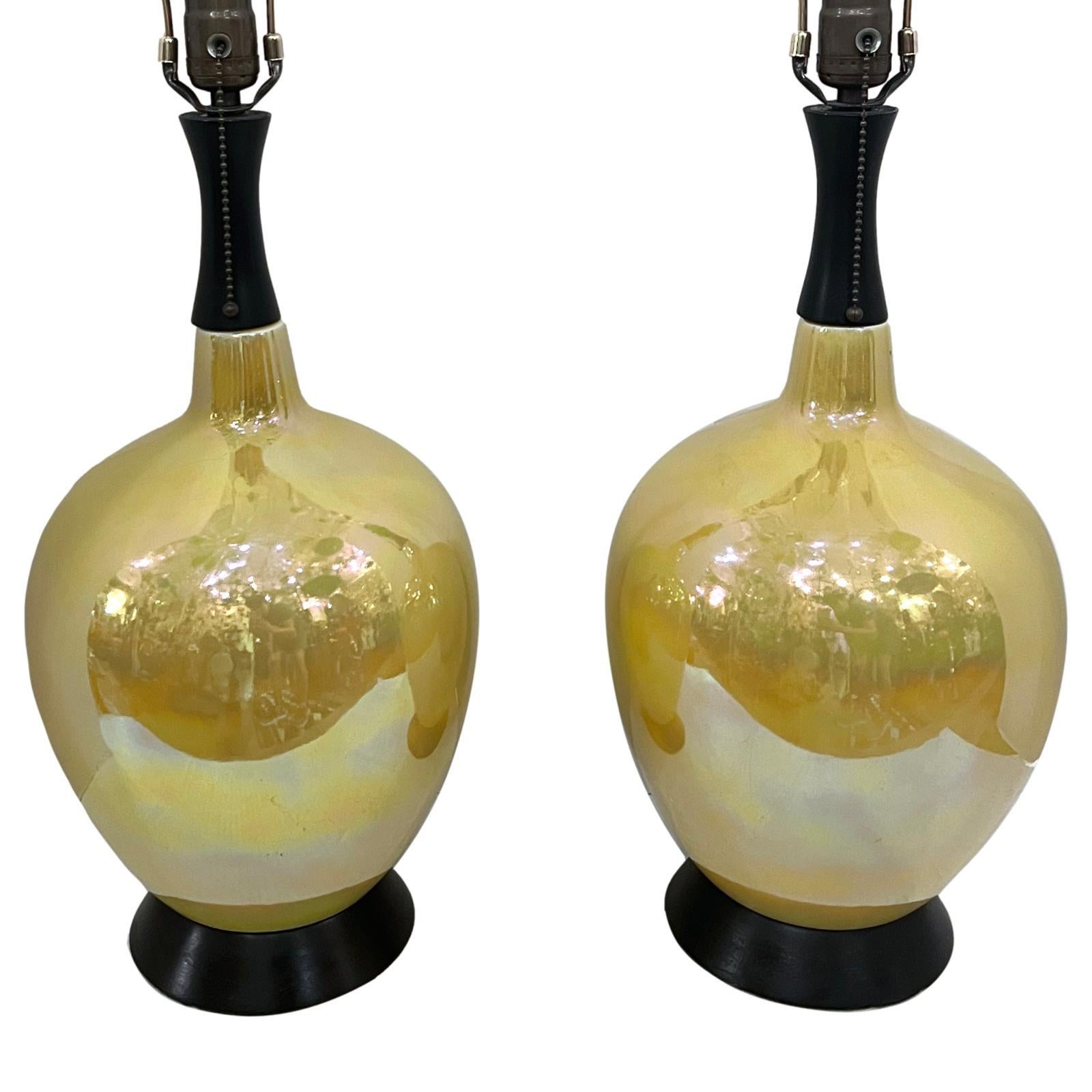 Paire de lampes italiennes en porcelaine lustrée des années 1950 avec des bases ébonisées.

Mesures :
Hauteur du corps : 18.5
