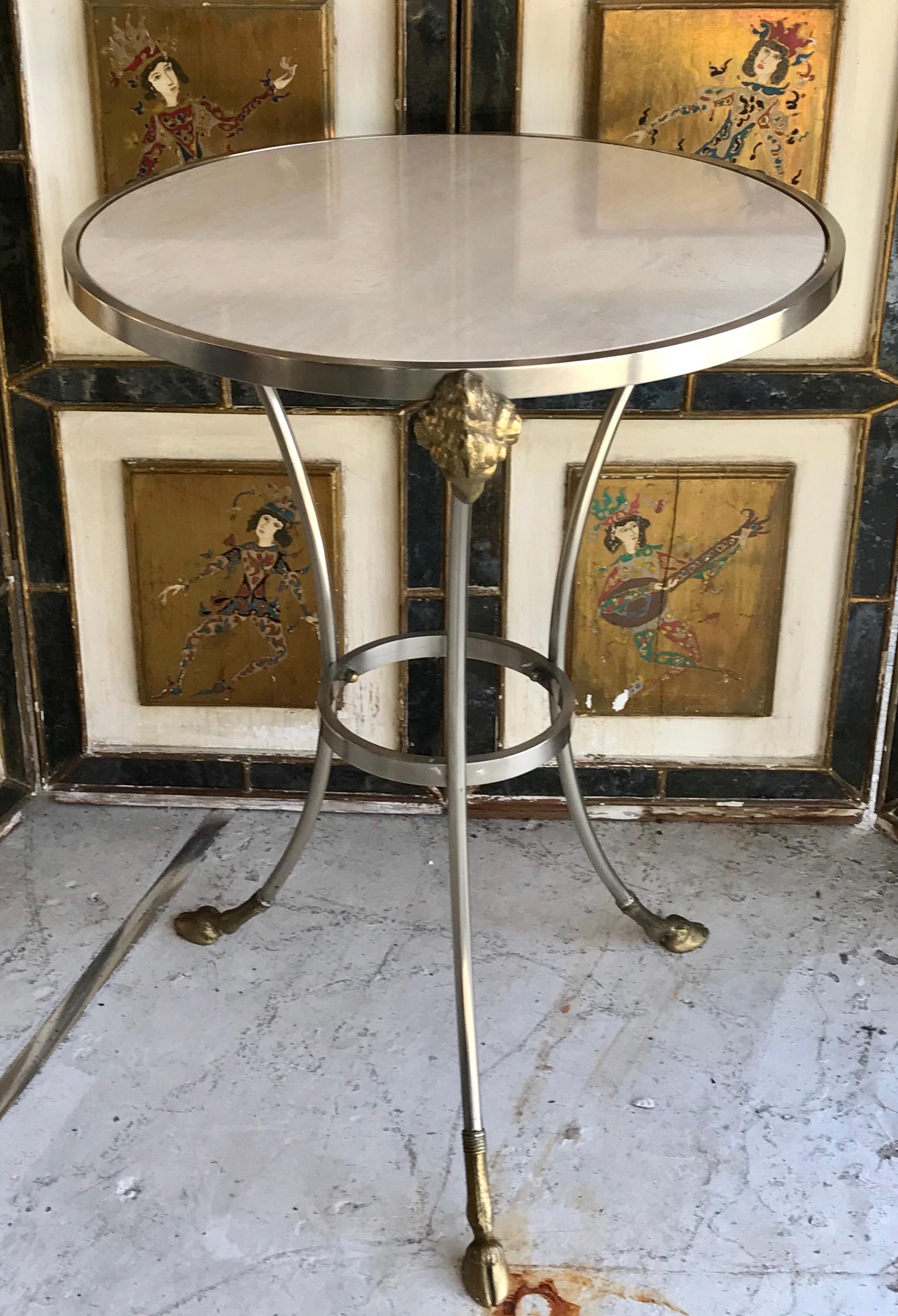 Pair of stunning Maison Jansen brass and brushed nickel Ram’s head and hooves gueridons with natural white travertine table tops.