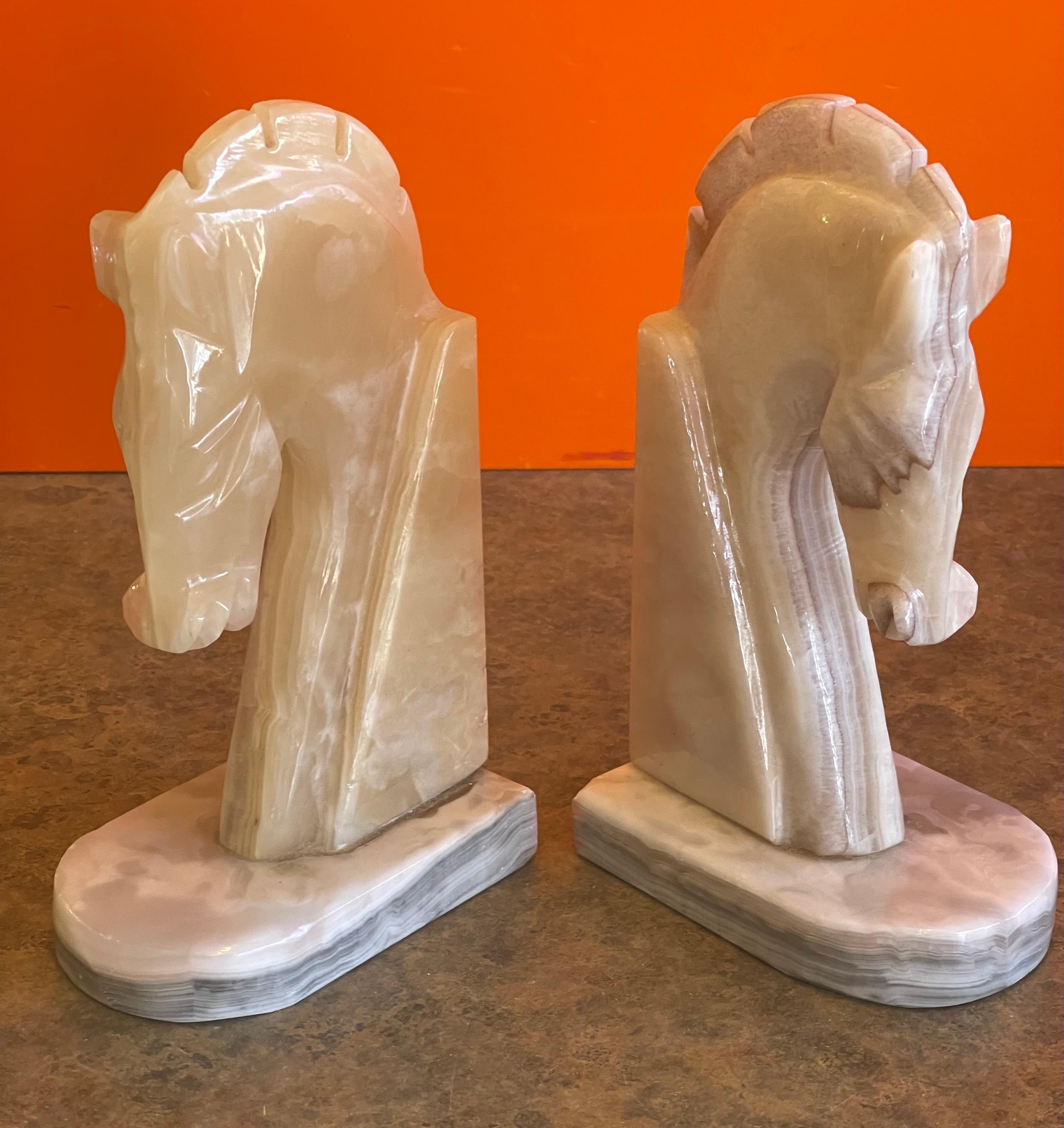 Very stylish pair of mid-century marble horse head bookends, circa 1970s. The bookends are heavy and solid and well crafted. They measure 8.5