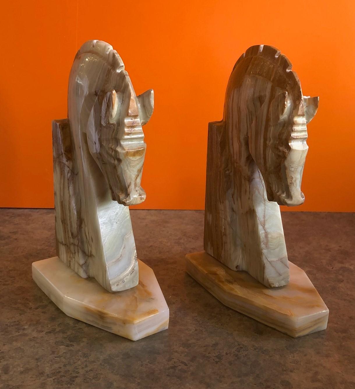 Very stylish pair of midcentury marble horse head bookends, circa 1970s. The bookends are heavy and solid and well crafted. They would make a great addition to any office or den.