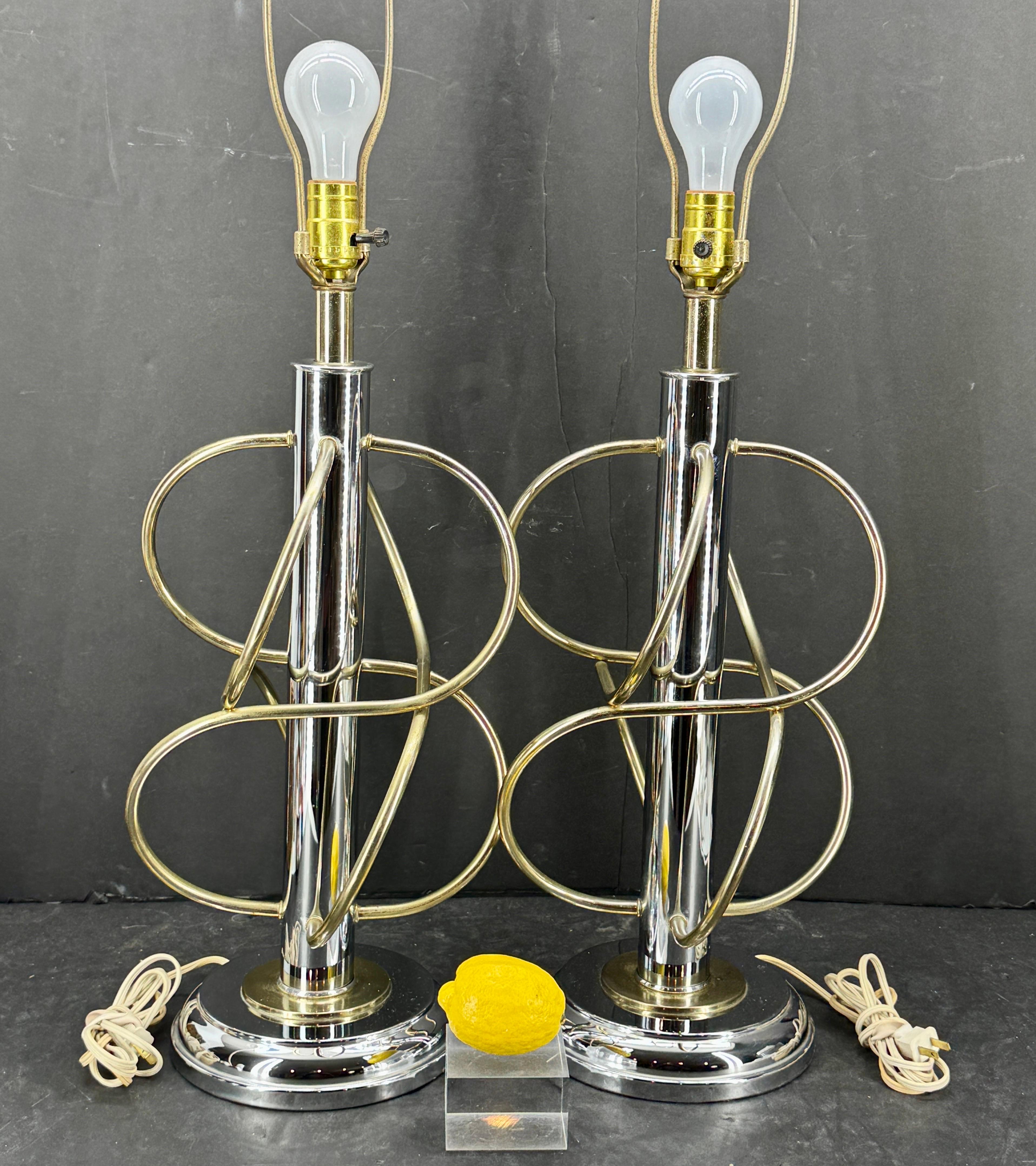 Mid-Century Modern Pair of Geometric Metal Table Lamps. Very versatile pair of MCM lamps that are intertwined using two metals chrome and brass, exemplifying the mid-century time period. The bases of the unique lamps are also mixed metal as well,