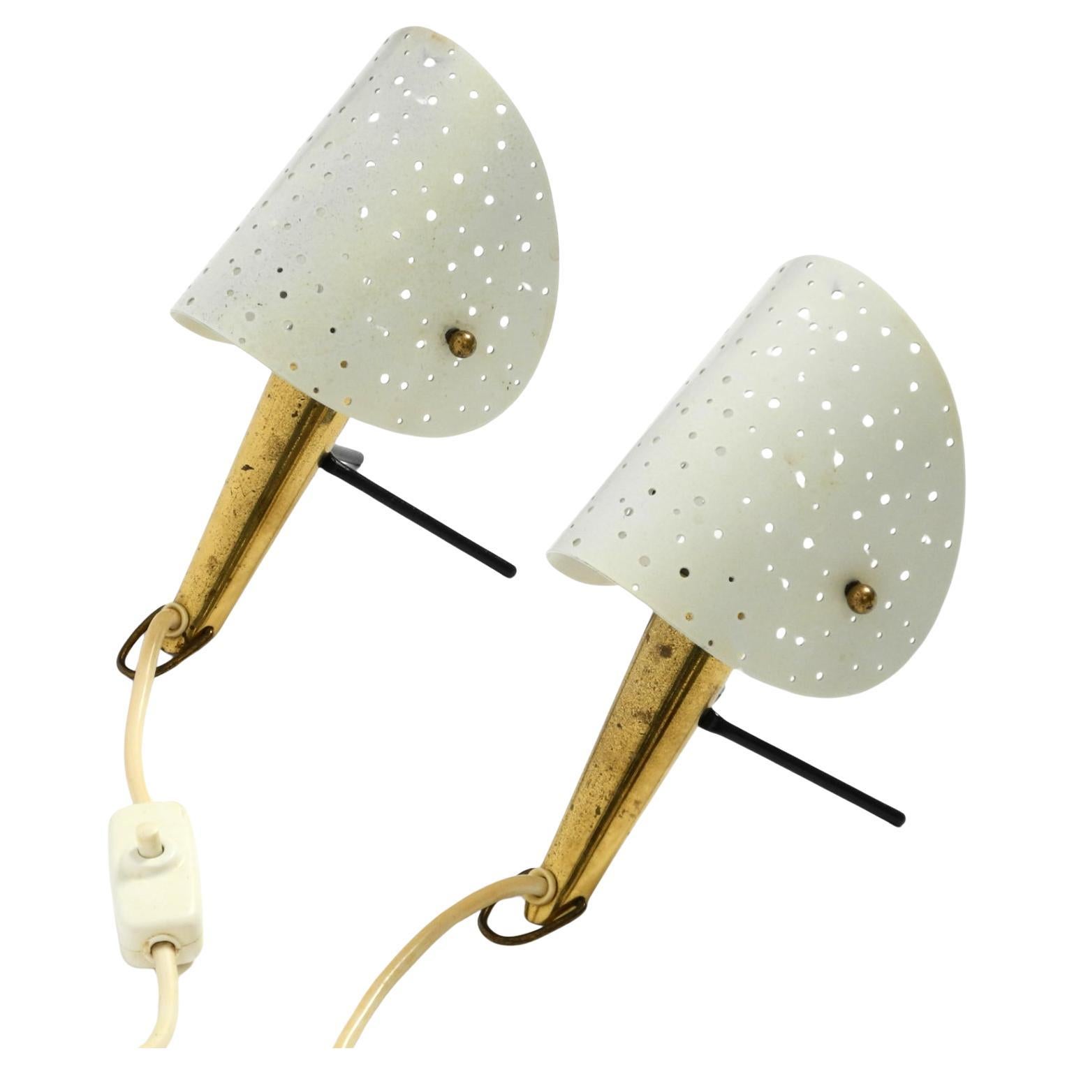 Pair of beautiful Mid Century Modern metal brass table and wall lamps by Ernest Igl.
Manufacturer is Hillebrand Leuchten. Made in Germany.
They can be used as table lamps or, with the two hooks on the base, hung on the wall and used as wall