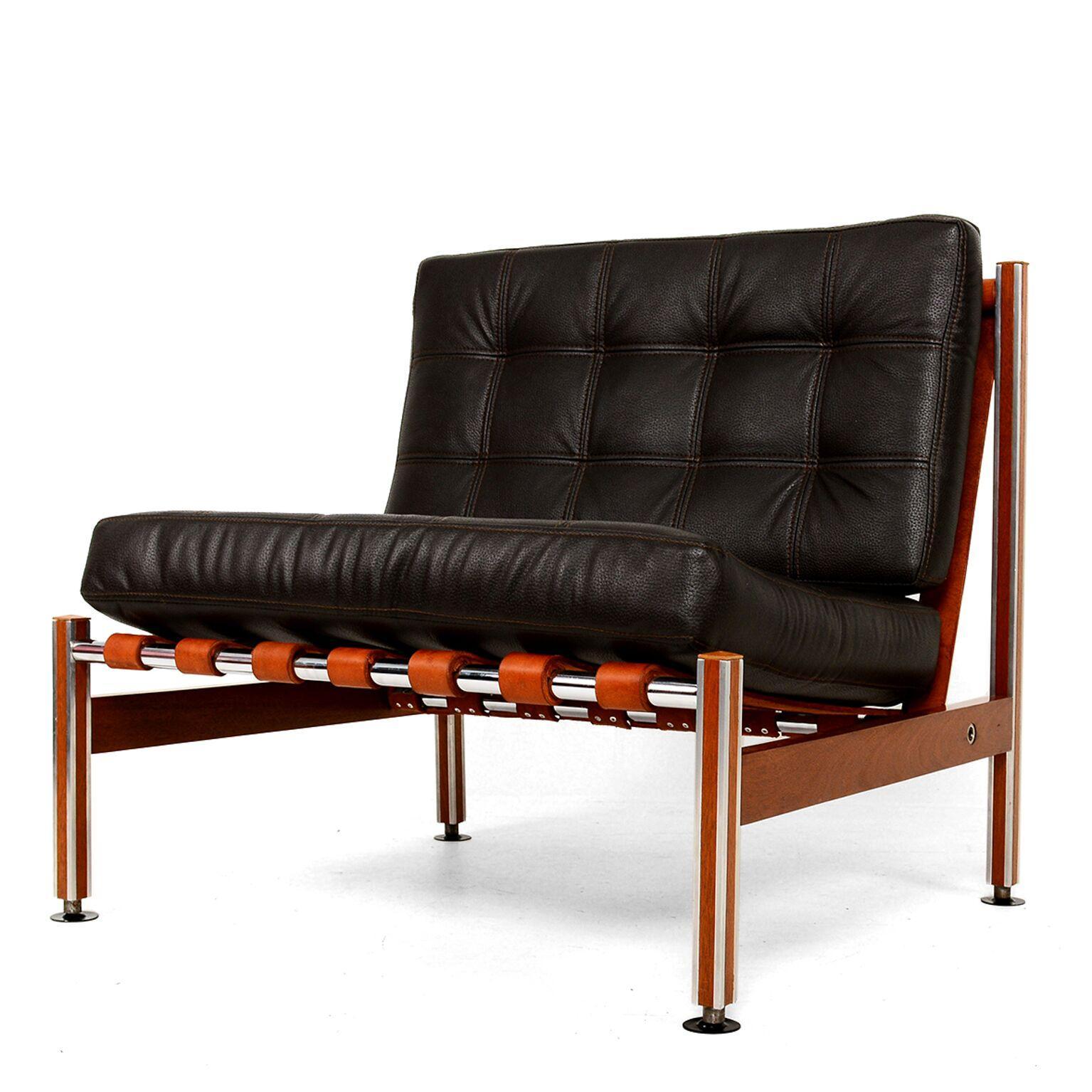 Barcelona Style
Faux Black Leather Barcelona Style Lounge chairs constructed in Aluminum on a Mahogany Wood frame.
In the classic Barcelona design of Ludwig Mies van der Rohe. No maker stamp is present.
Tanned Leather straps are secured to three