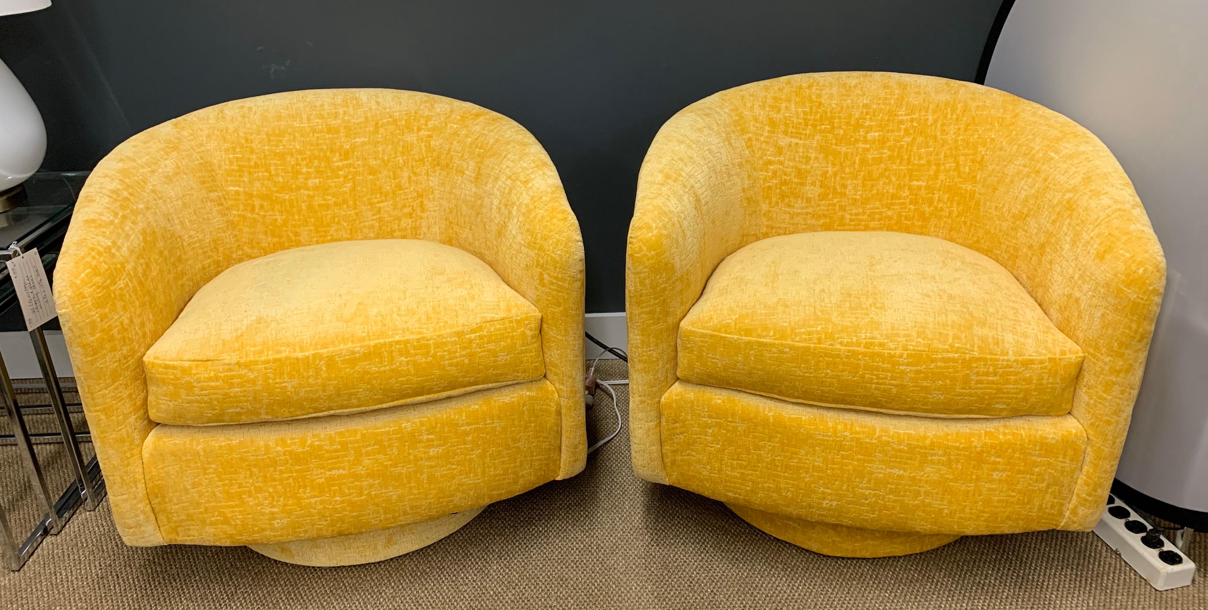 Stunning pair of midcentury Milo Baughman barrel back swivel chairs with new upholstery. These chairs feature 360 degree swivel capability as well as great lines and scale. These are true period pieces, not reproductions. The soft textured chenille