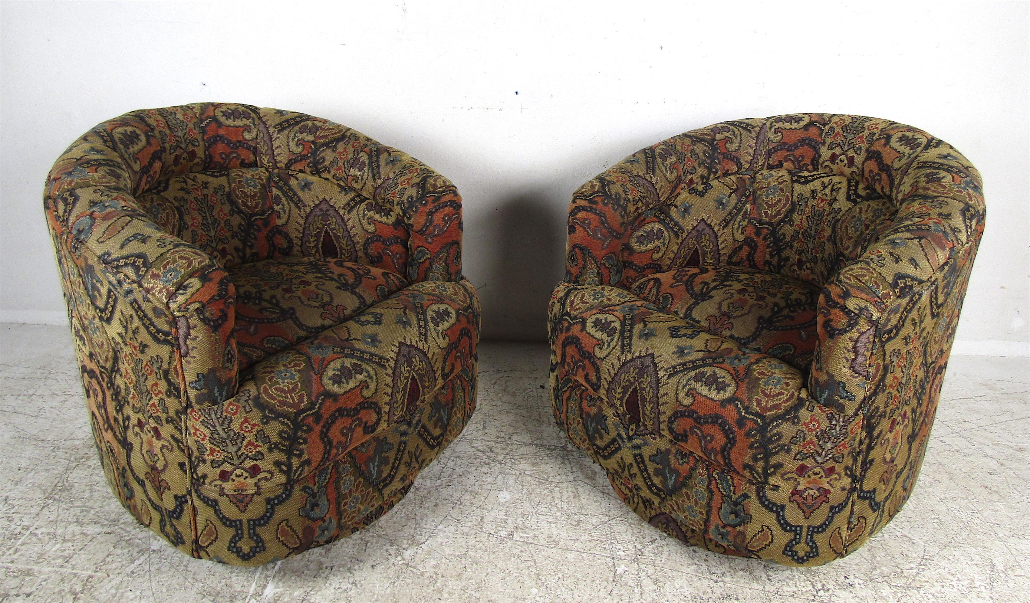 A stunning pair of vintage modern lounge chairs that include the label for Thayer Coggin underneath. An unusual design with abnormally placed cushions for added comfort. The plush colorful upholstery would complement any seating arrangement. The