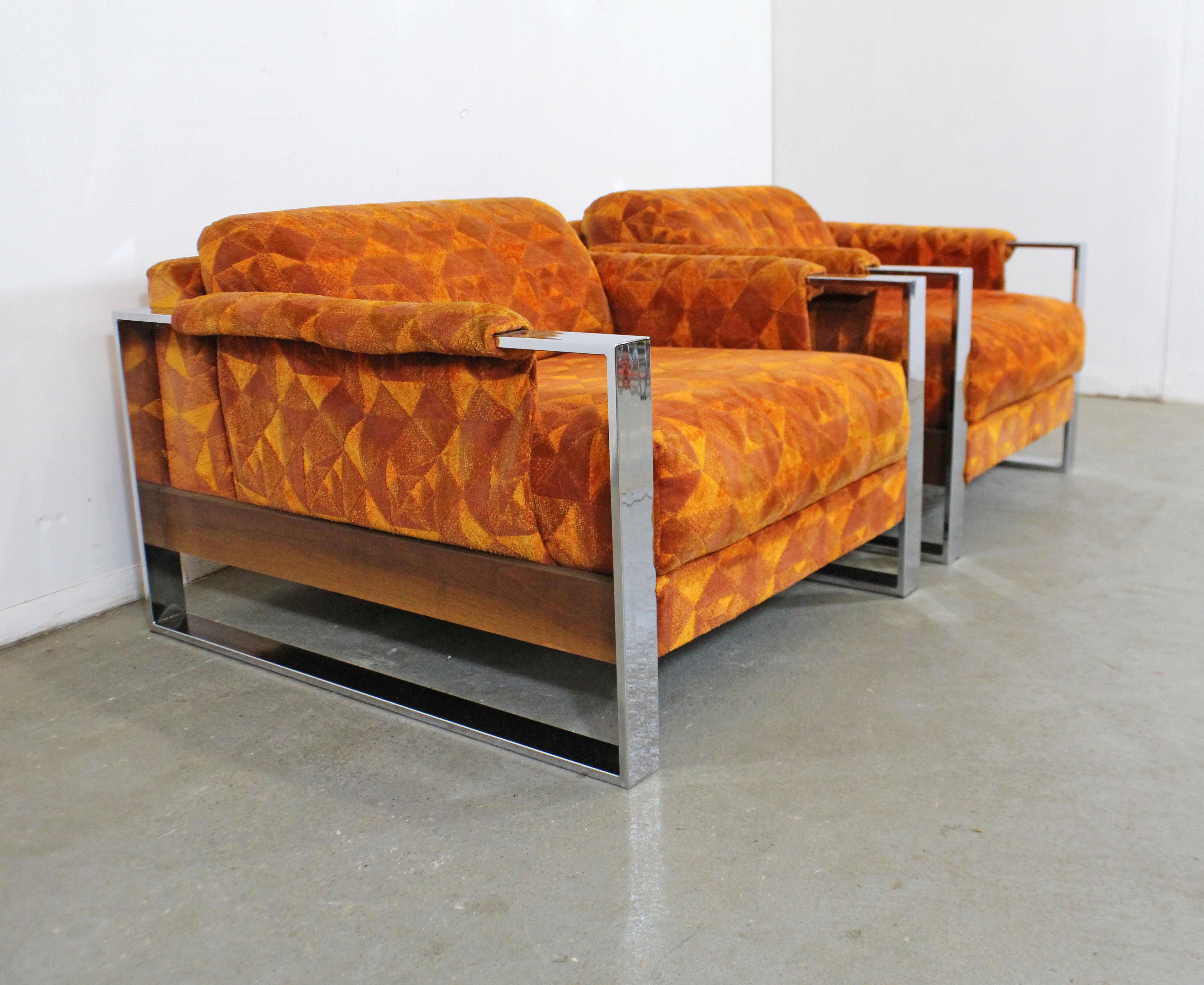 What a find. Offered is a pair of rare vintage Mid-Century Modern lounge chairs, designed by Adrian Pearsall for Craft Associates. These chairs feature geometric orange upholstery and chrome bases. They are in good condition, showing slight age wear