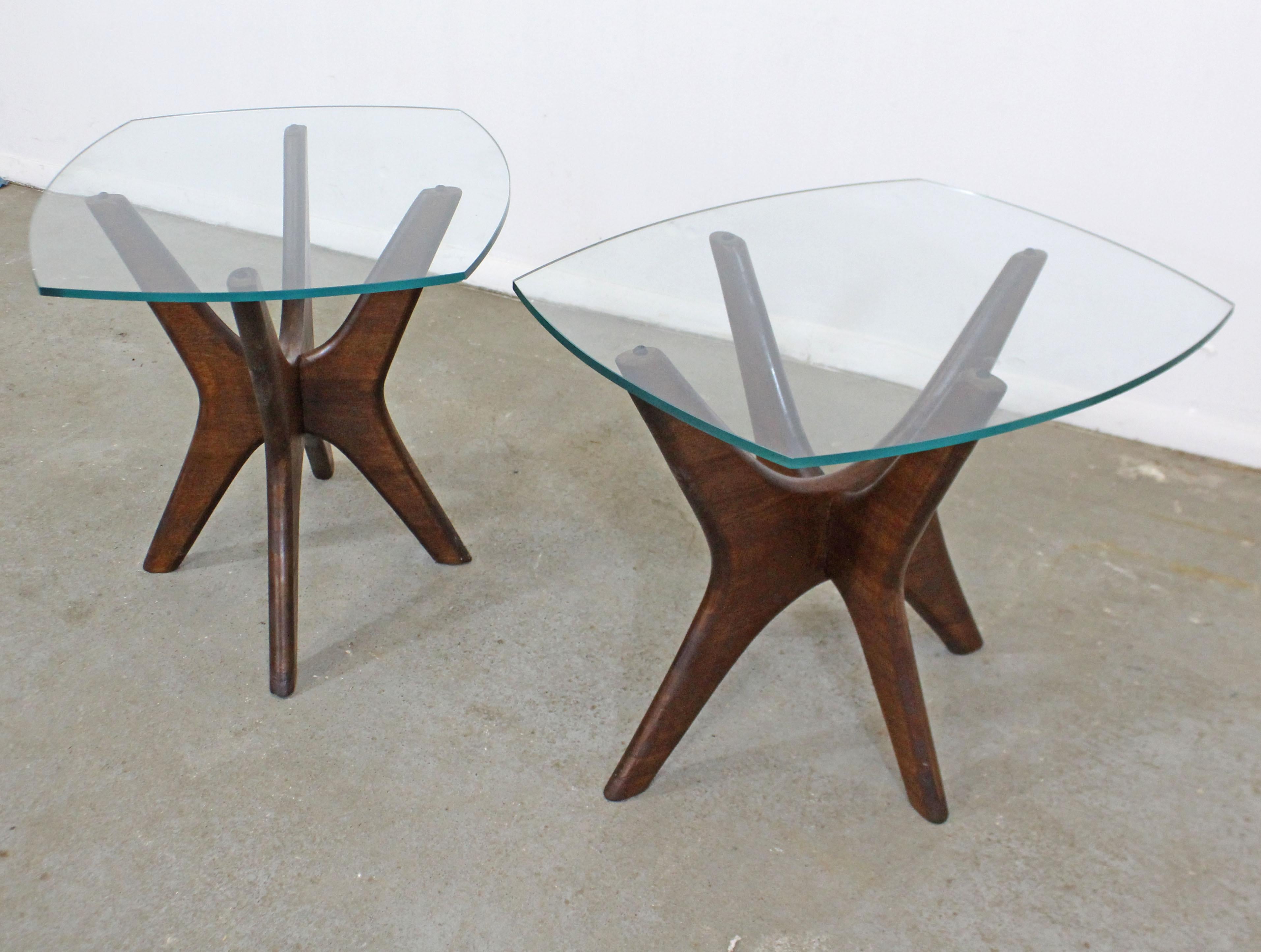 Offered is an authentic pair of Adrian Pearsall 'Jacks' end tables sculpted wooden bases and thick glass tops. In good condition for their age (surface scratches, small chips, age wear, see photos). They are not signed. A great piece to add to any