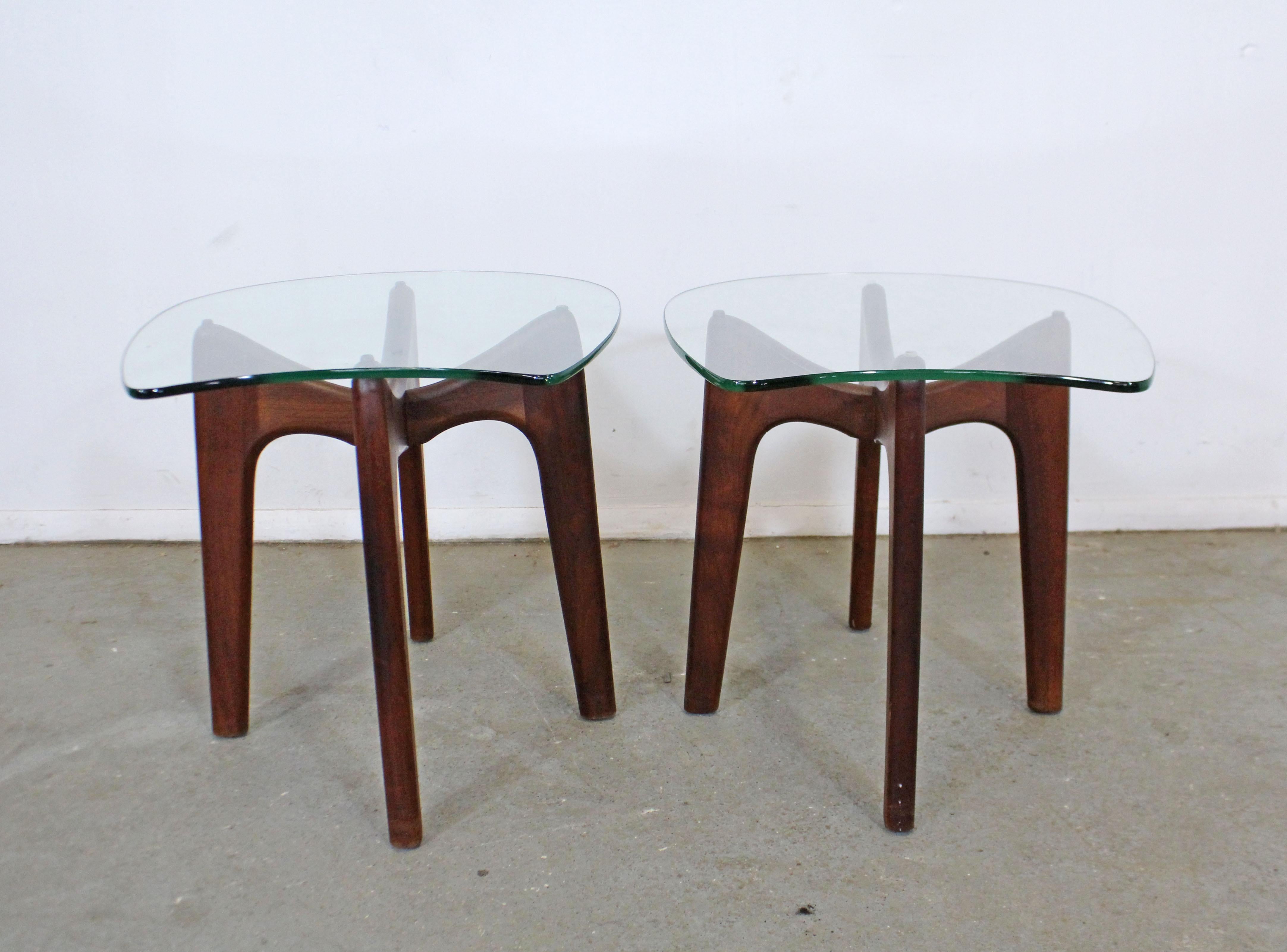 Offered is an authentic pair of Adrian Pearsall 'Stingray' end tables sculpted wooden bases and thick glass tops. They're in very good condition for their age such as slight surface scratches on glass and wood, age wear. They are not signed. A great