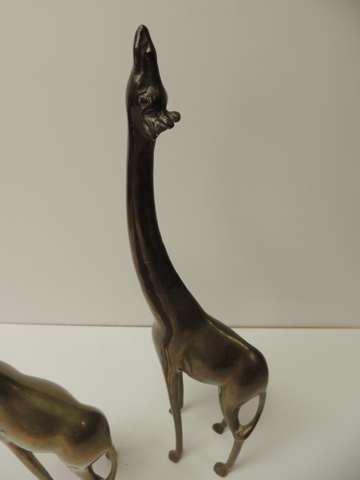 Pair of Mid-Century Modern Asian brass giraffes accent decor animals
Pair of male and female giraffes sculptures in antique brass finish. 
Asia, 1980.
Size: Male: 19” H x 6” D x 2.5” W
Size: Female: 11.5” H x 8” D x 3” W.
 