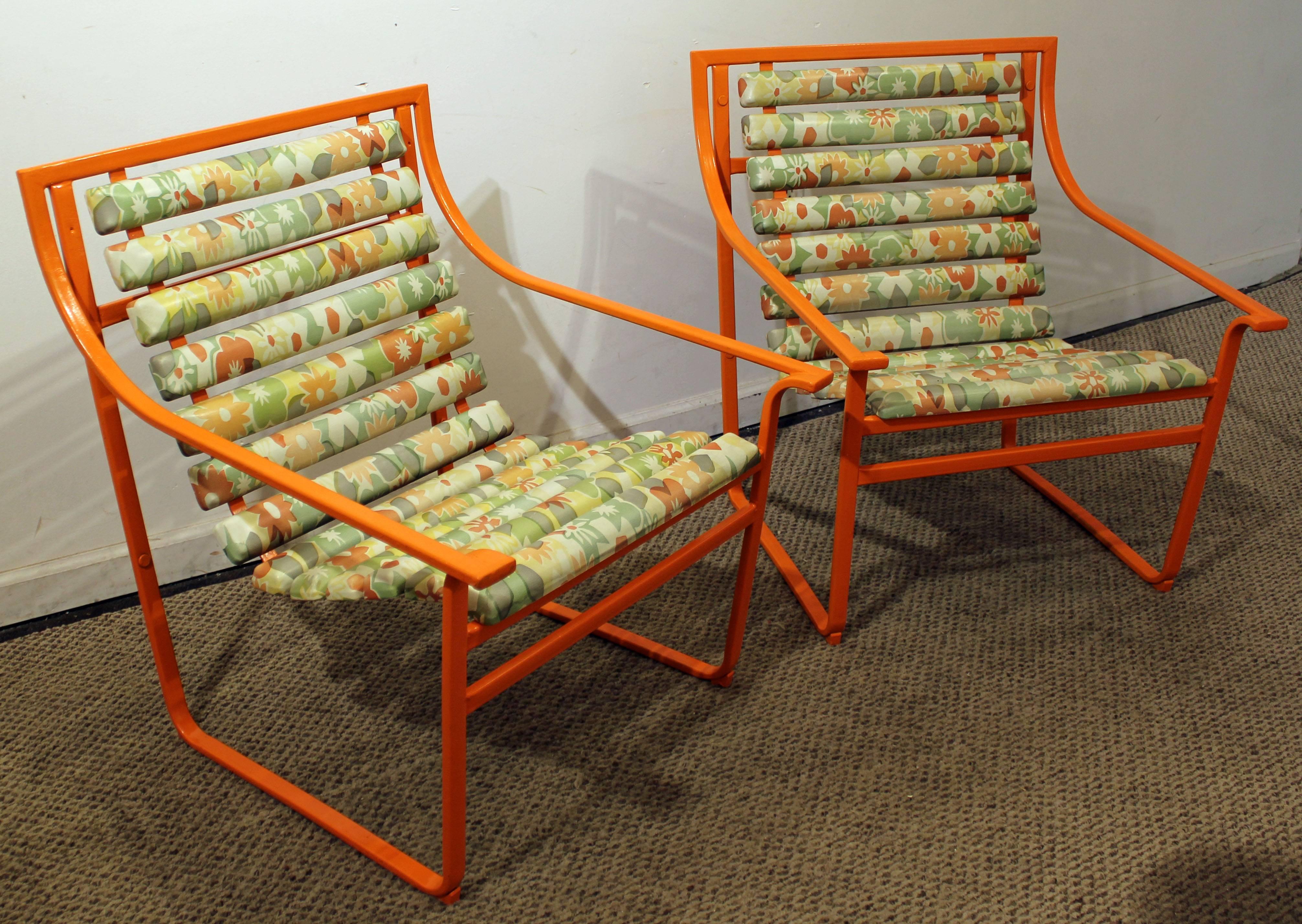 This set includes a pair of outdoor armchairs made by Samsonite. They have been repainted with an atomic orange color and include original upholstery.