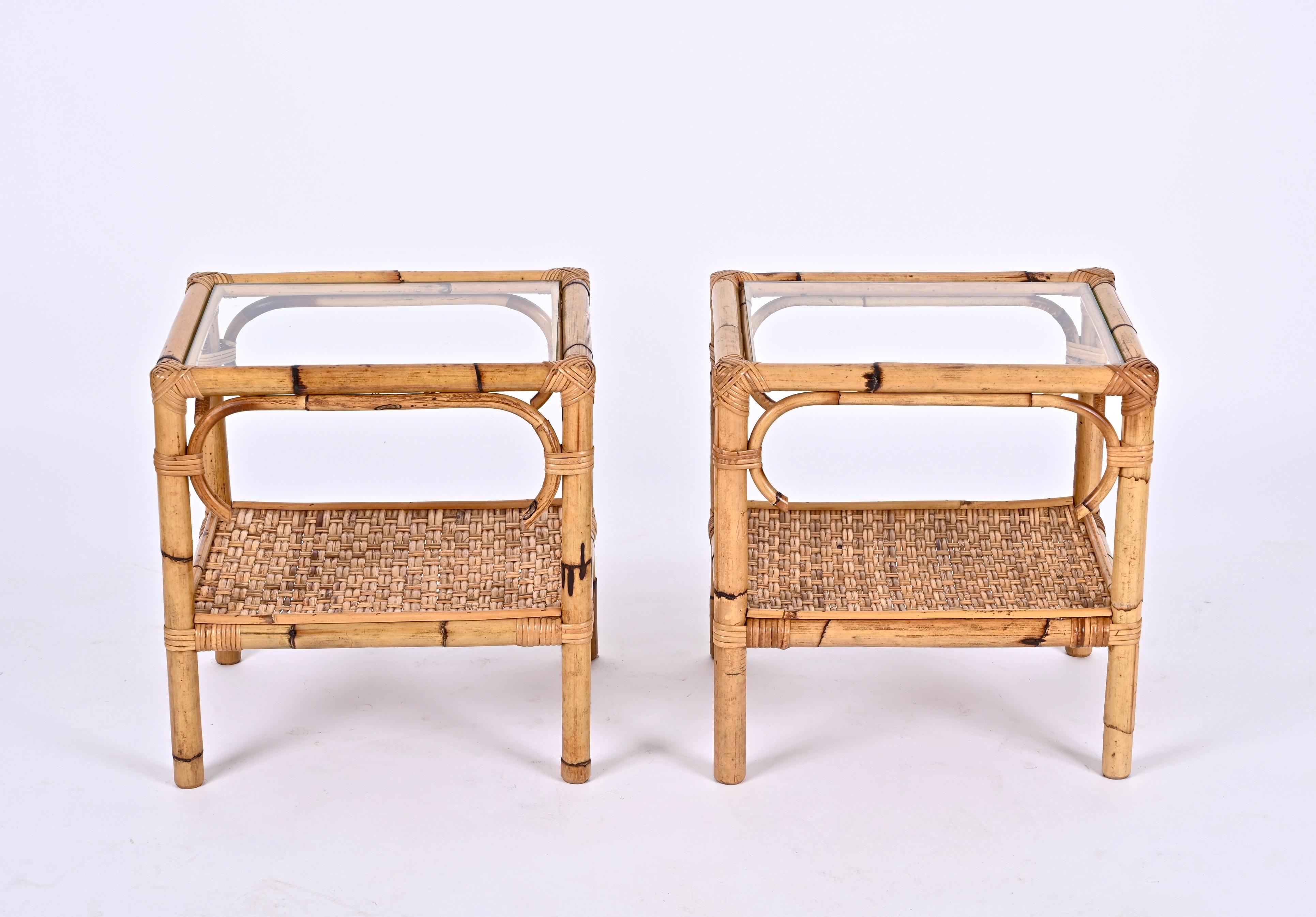 Amazing Pair of Mid-Century Modern Bamboo and Rattan Nightstands, designed in Italy in the 70's.
These stunning bedsides  feature a structure made in bamboo and enriched by rattan and wicker decorations on each side and a glass top.

These small