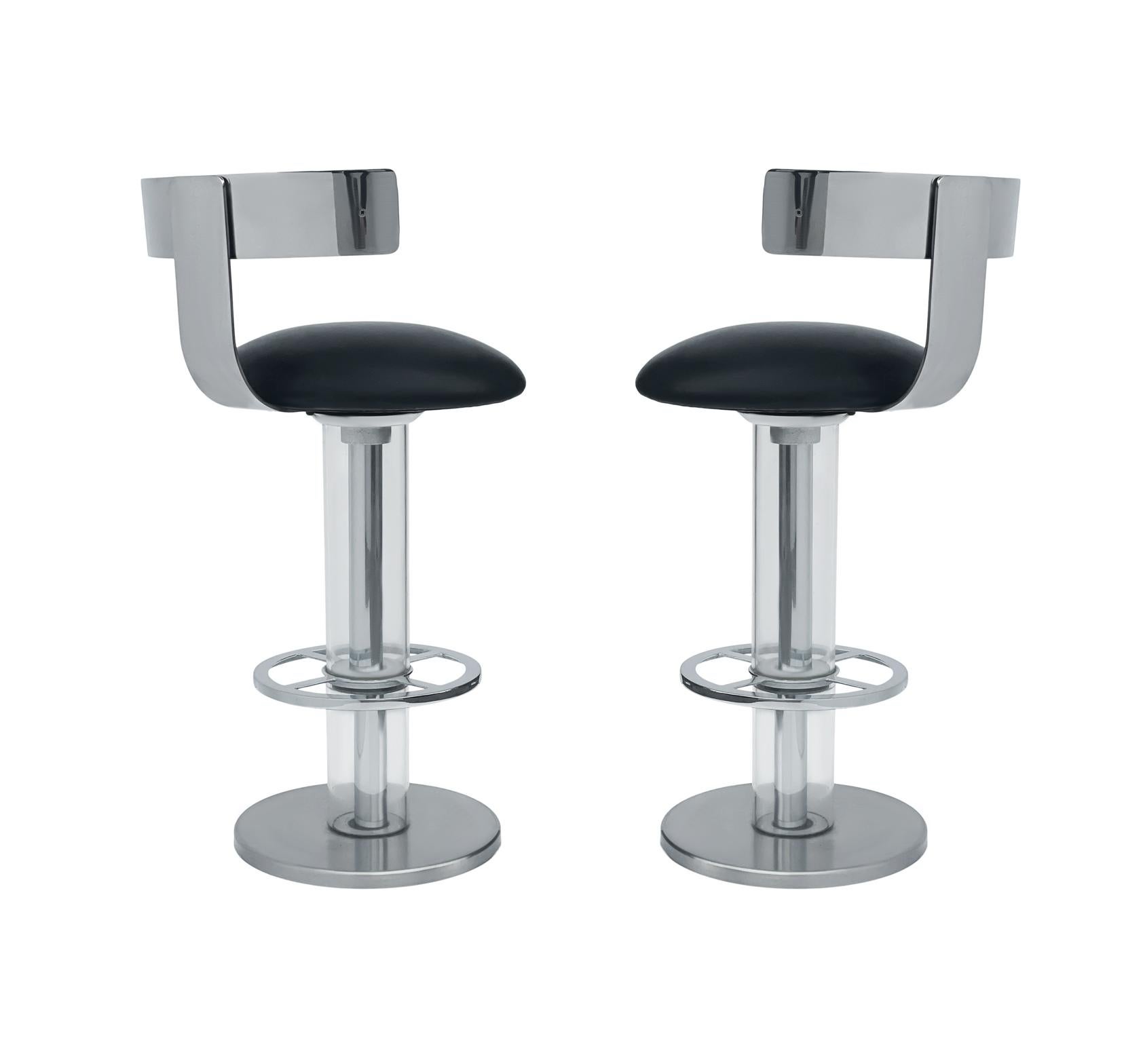 A well made matching pair of stools made by Design for Leisure circa 1980's. These feature heavy stainless steel construction with clear acrylic. Leather seat have some moderate wear and could use recovering.
