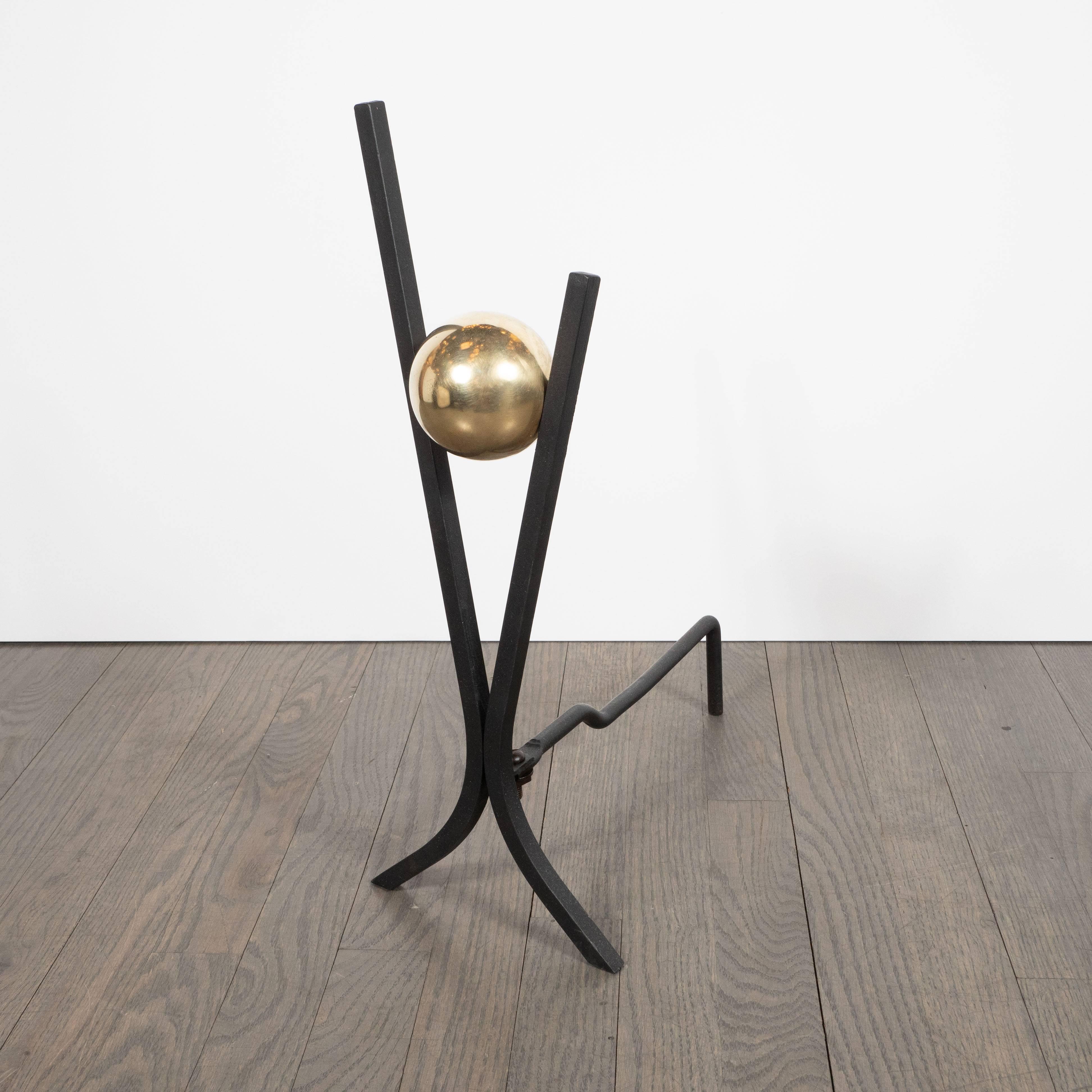 This stunning and graphic pair of andirons were realized by the fabled American designer behind New York City's iconic Radio City Music Hall, Donald Deskey, circa 1950 for Bennet Company. They feature two hourglass X-form streamlined bodies composed