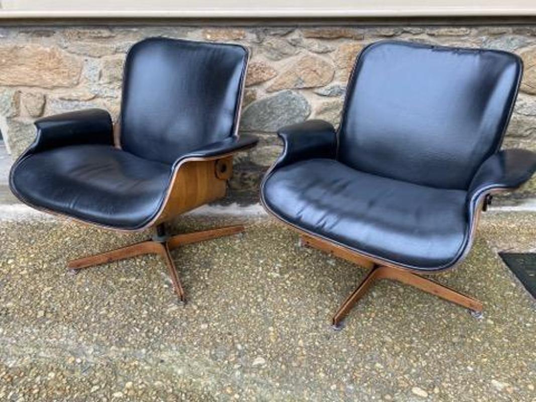 Pair of Mid-Century Modern Black Leather and Walnut Mr. Chair by Plycraft Armchairs. These chairs have the lovely lines and comfort you would expect from mid-century design. The Mr Chair was designed by George Mulhauser and was a very successful