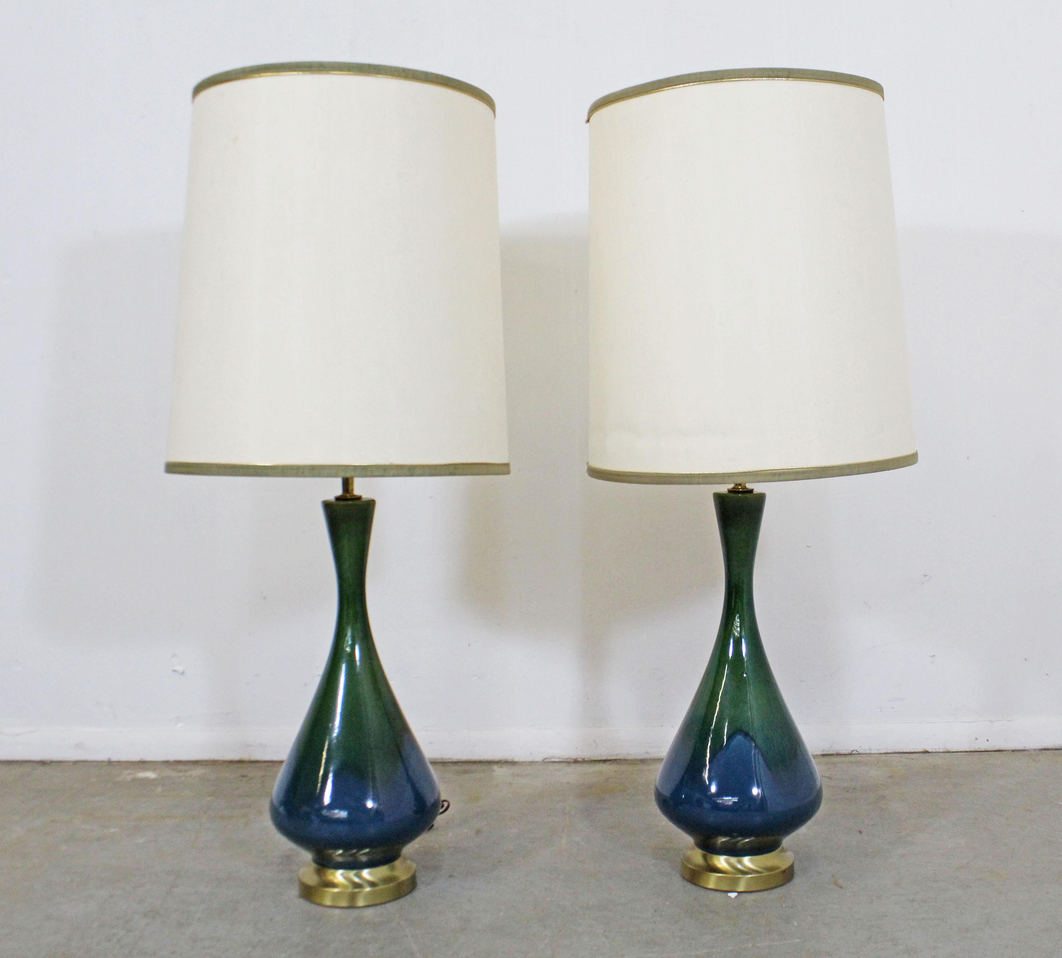 Pair of Mid-Century Modern blue green drip glaze table lamps

Offered is a unique Mid-Century Modern pair of table lamps. They are made of blue and green drip-glazed ceramic with brass bases. They are in good, working condition showing some