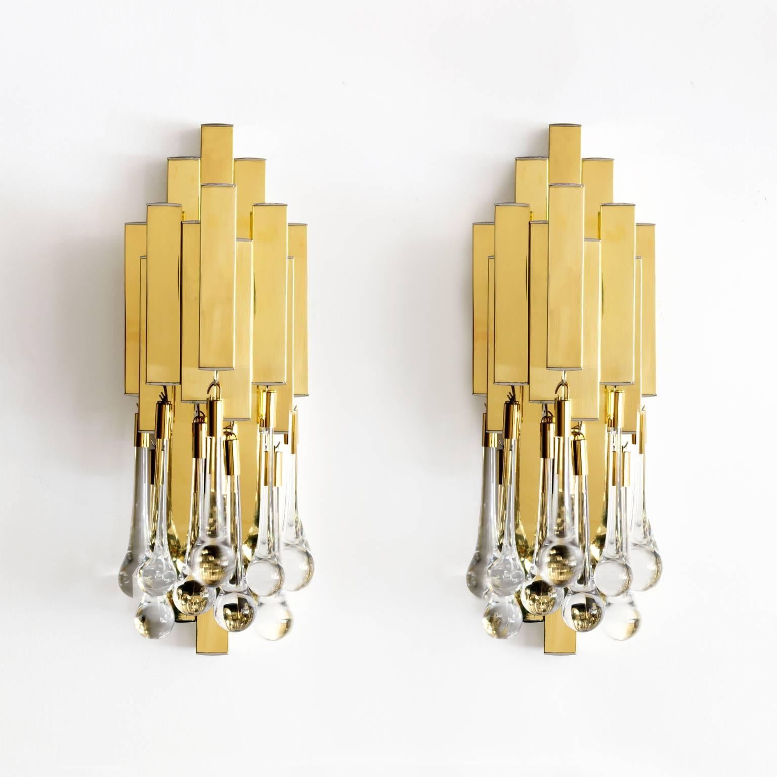 Pair of polished brass sconces from Lumica, Barcelona Spain. Each sconce has two candelabra base sockets (newly rewired for use in the USA) and nine tear drop crystals. 

Measures: Height 15.5”, width 6.25”, depth 6.5”.