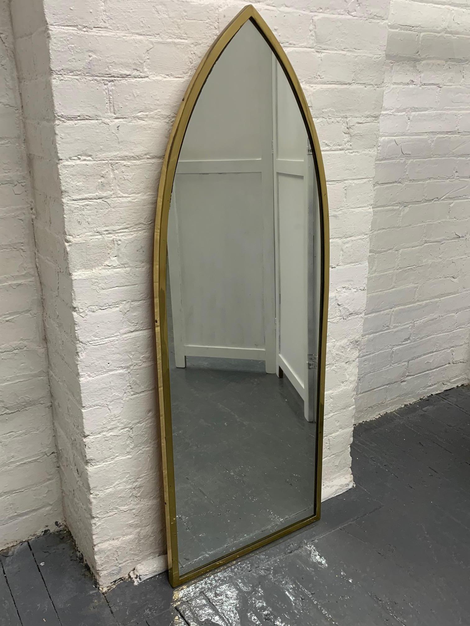 Pair of Mid-Century Modern brass arched mirrors.