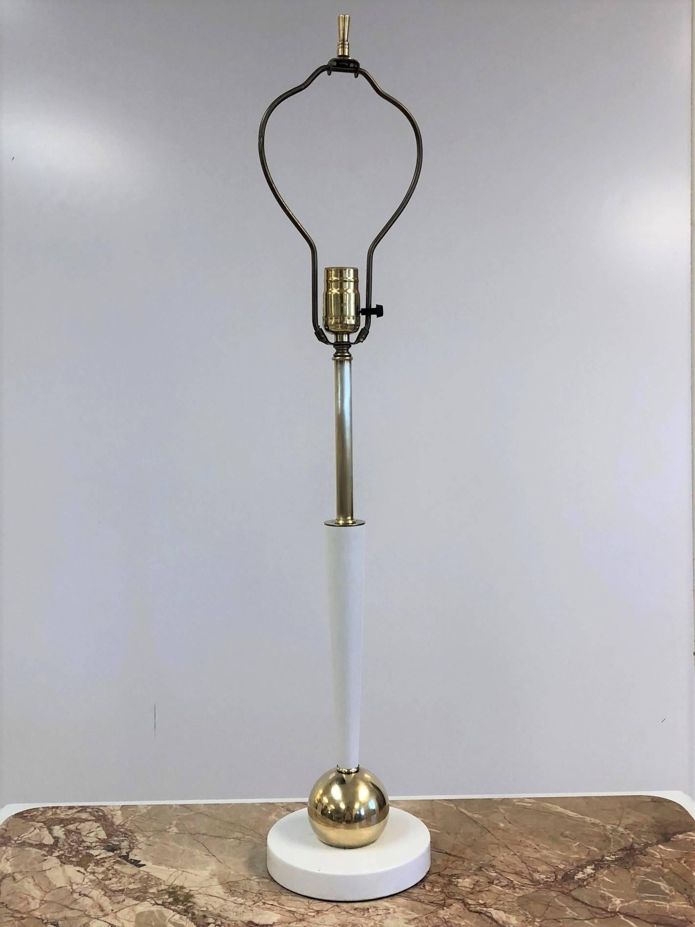 Painted white lamps with brass ball to the base. 
Measures: 30.75 H (to top of finial) x 19.5 H (under bulb socket). Base: 6.5 in diameter. 
Shades not included.