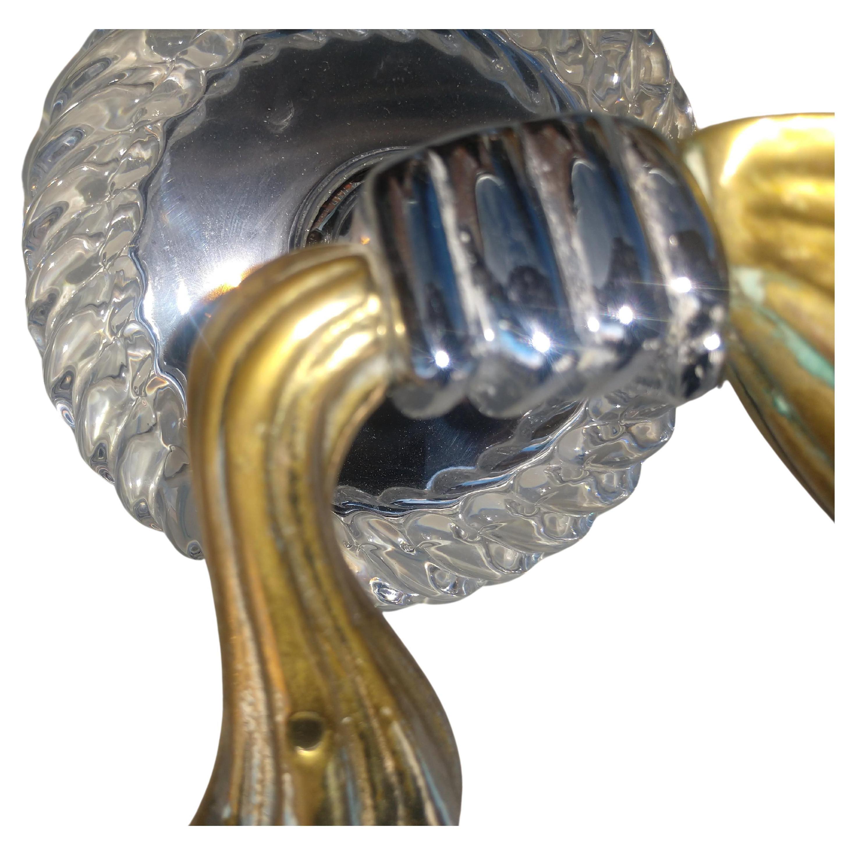 Fabulous pair of very elegant and sophisticated brass, glass and chrome wall sconces. Brass swag drapes which are held by chrome hands and decorated with twisted glass rings. High quality. In excellent vintage condition with minimal wear. Sound