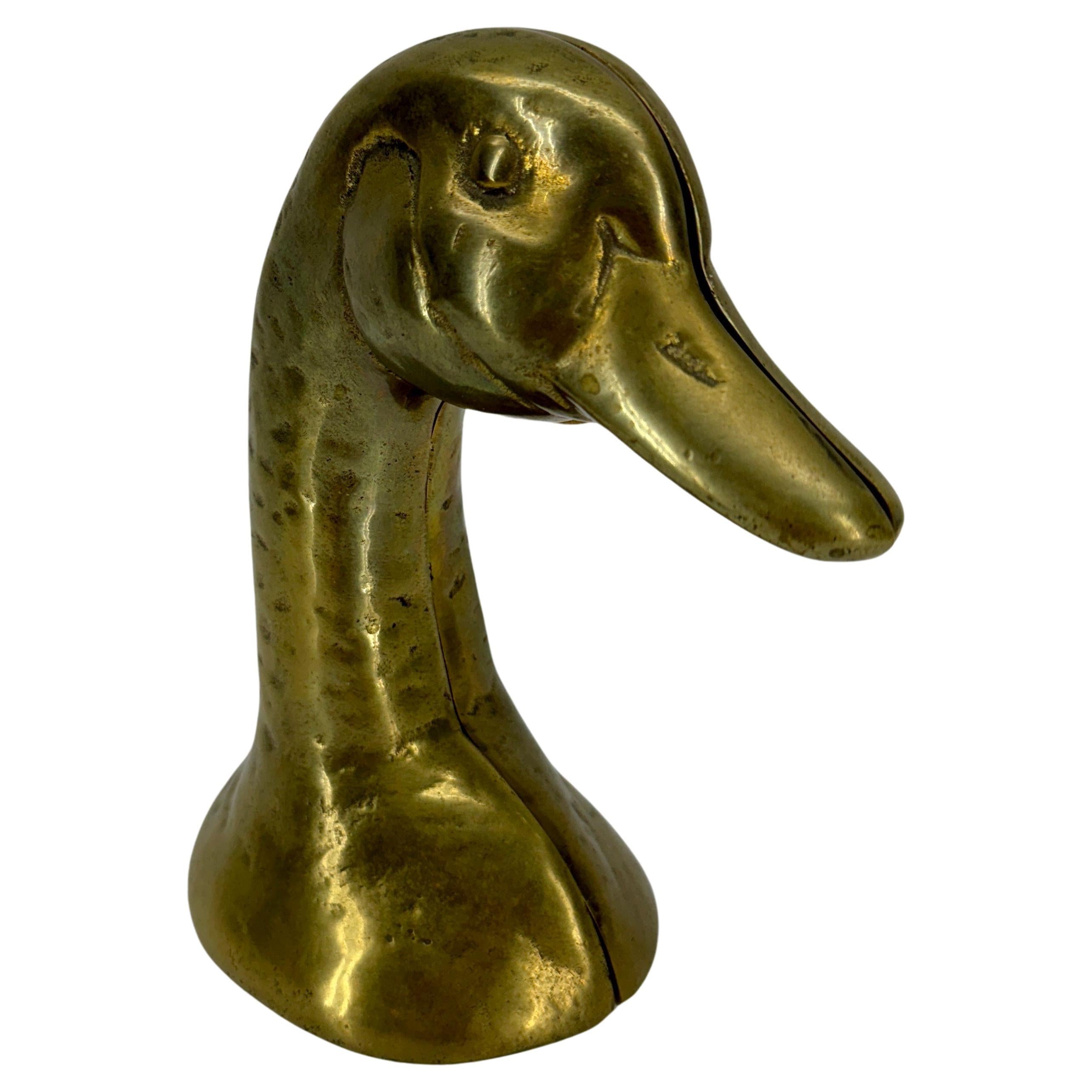 Set of Mid-Century Duck Brass Bookends Sculptures

Substantial in size and weight, these solid vintage brass ducks are both form and function. Fabulous pair displayed on a bookshelf or desk or standing alone as sculptures on a table as a statement