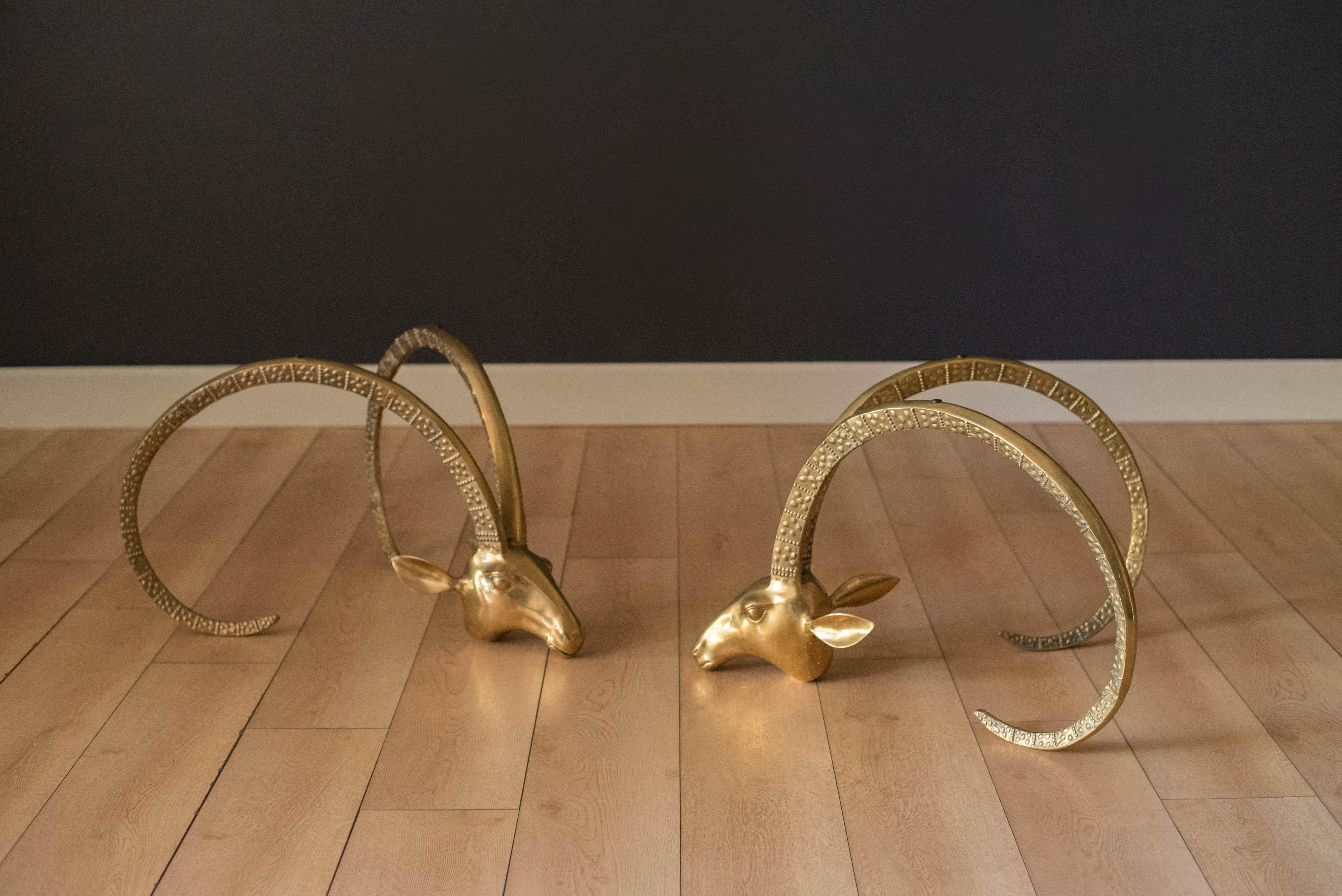 Vintage Ibex Rams head brass sculptures in the manner of Alain Chervet, circa 1970s. This sophisticated and dramatic focal point will be a statement piece in any interior living space. Versatile enough to form a coffee table or separately as a pair