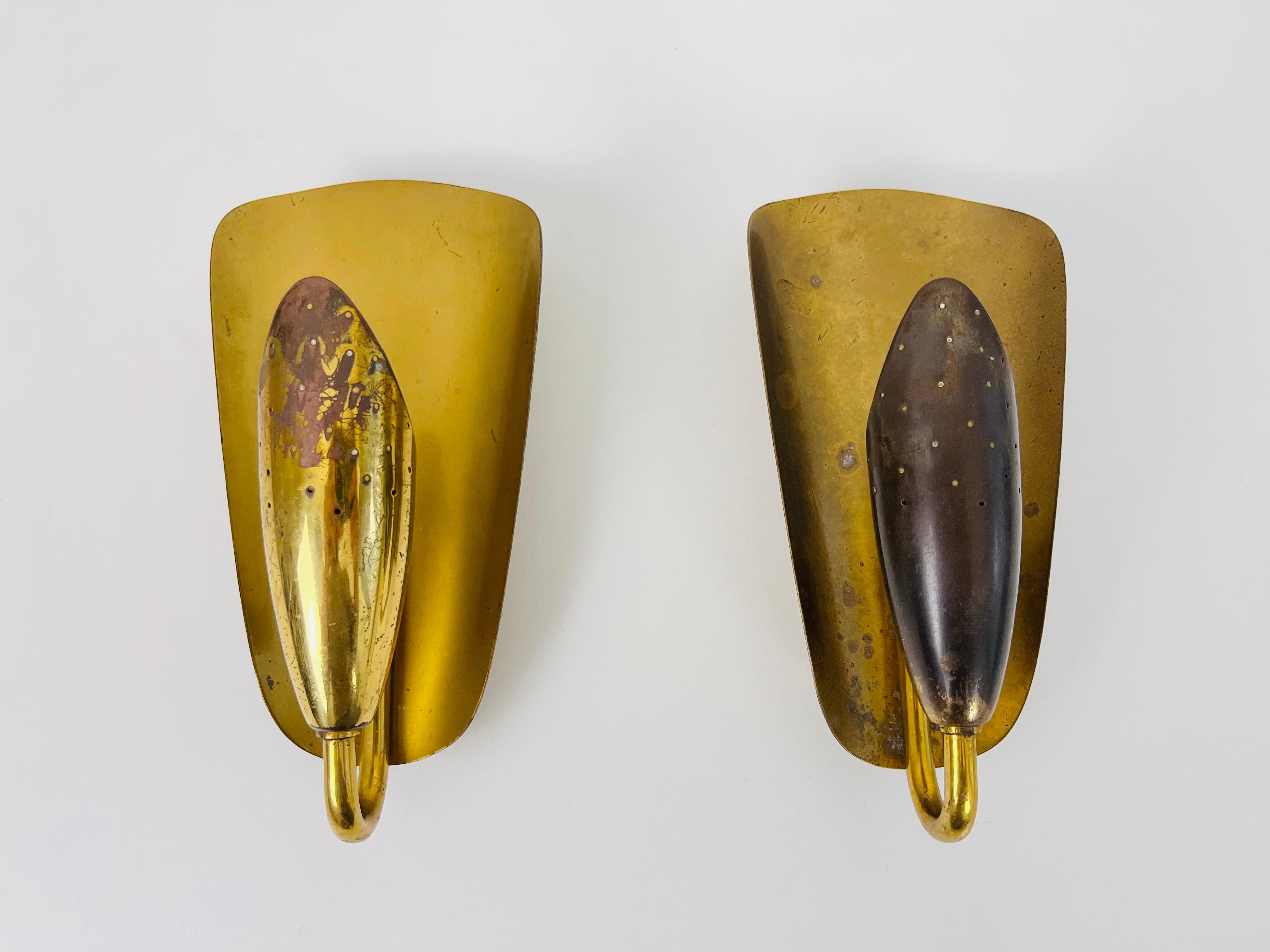 A beautiful pair of brass wall lamps made in Italy in the 1950s. The pair has an amazing midcentury design. The brass body is very thin and elegant.

The light requires E14 light bulbs. Works with both 120/220 V. Very good vintage