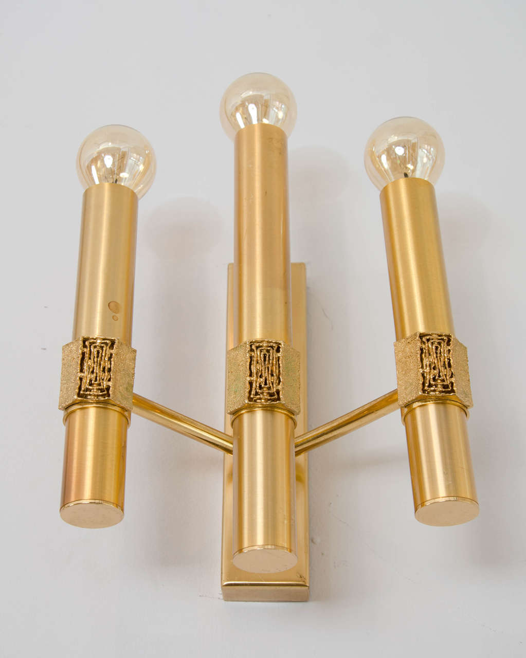 Triple-arm elegant wall sconces with bronze jewelry like cast ornaments on brushed brass tubes, attributed to Angelo Brotto for Esperia, 1960s, Italy.

