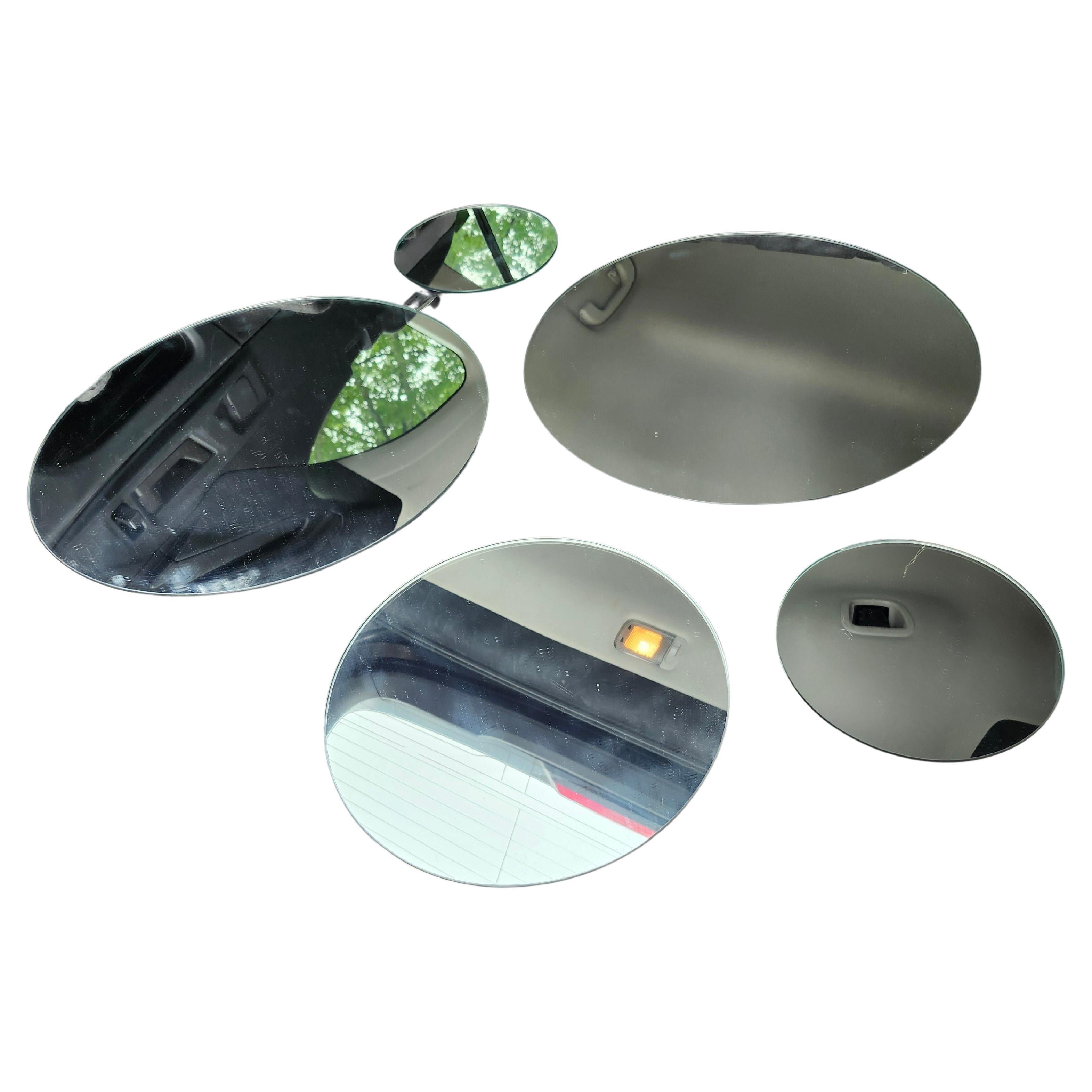 Fantastic c1970s brutalist disc mirror sculpture wall mirror configuration. Grouping of 5 round unframed mirrors in different sizes connected by chrome plated steel bars. A pair is available,  priced and sold individually.  In excellent vintage