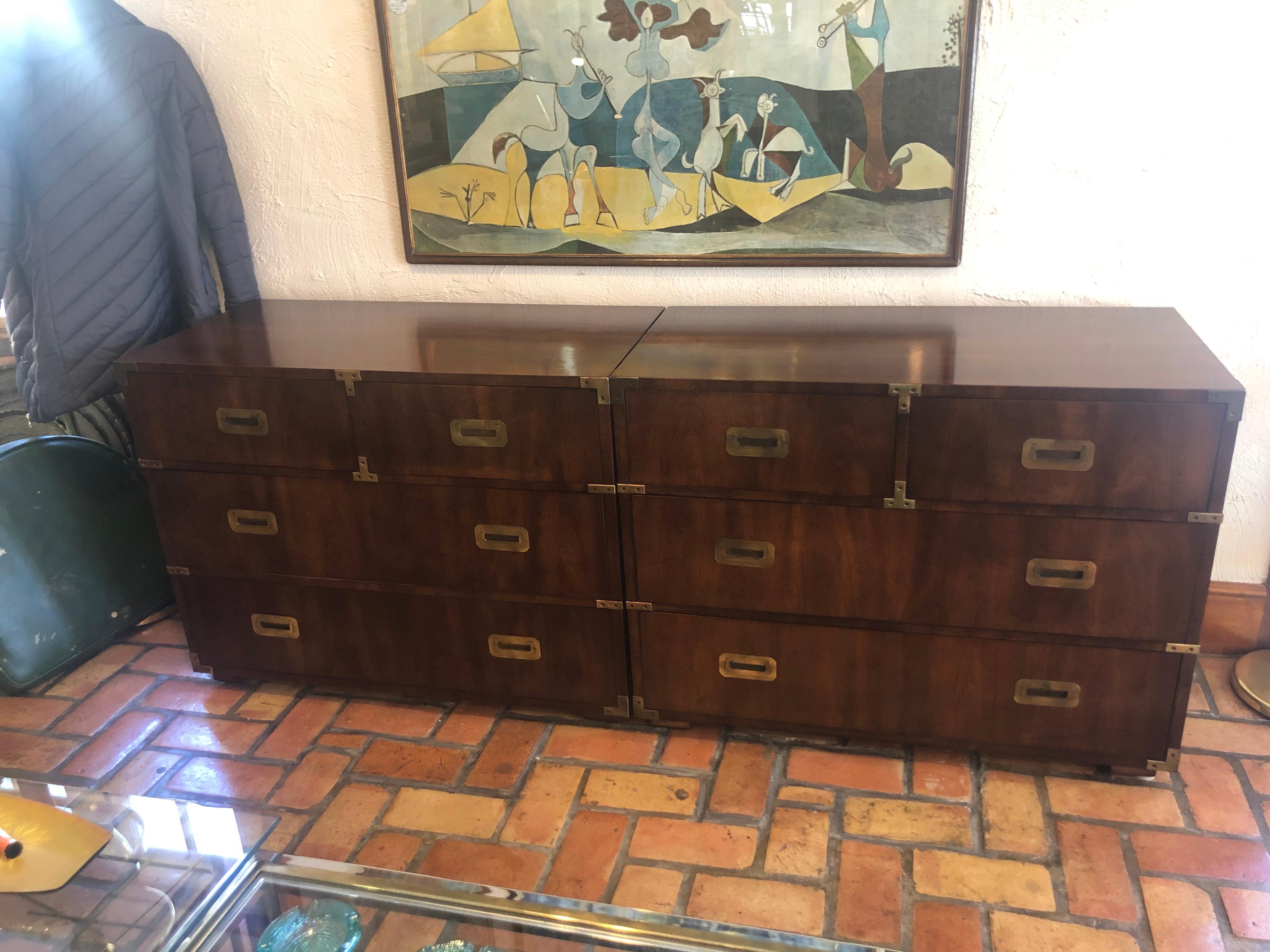 Pair of Mid-Century Modern campaign dressers by Henredon. Classic, timeless pieces. Rare to find a set in such good shape. Use as a pair of nightstands if you need oversized storage. Signed inside. Some drawers have vertical drawer dividers.