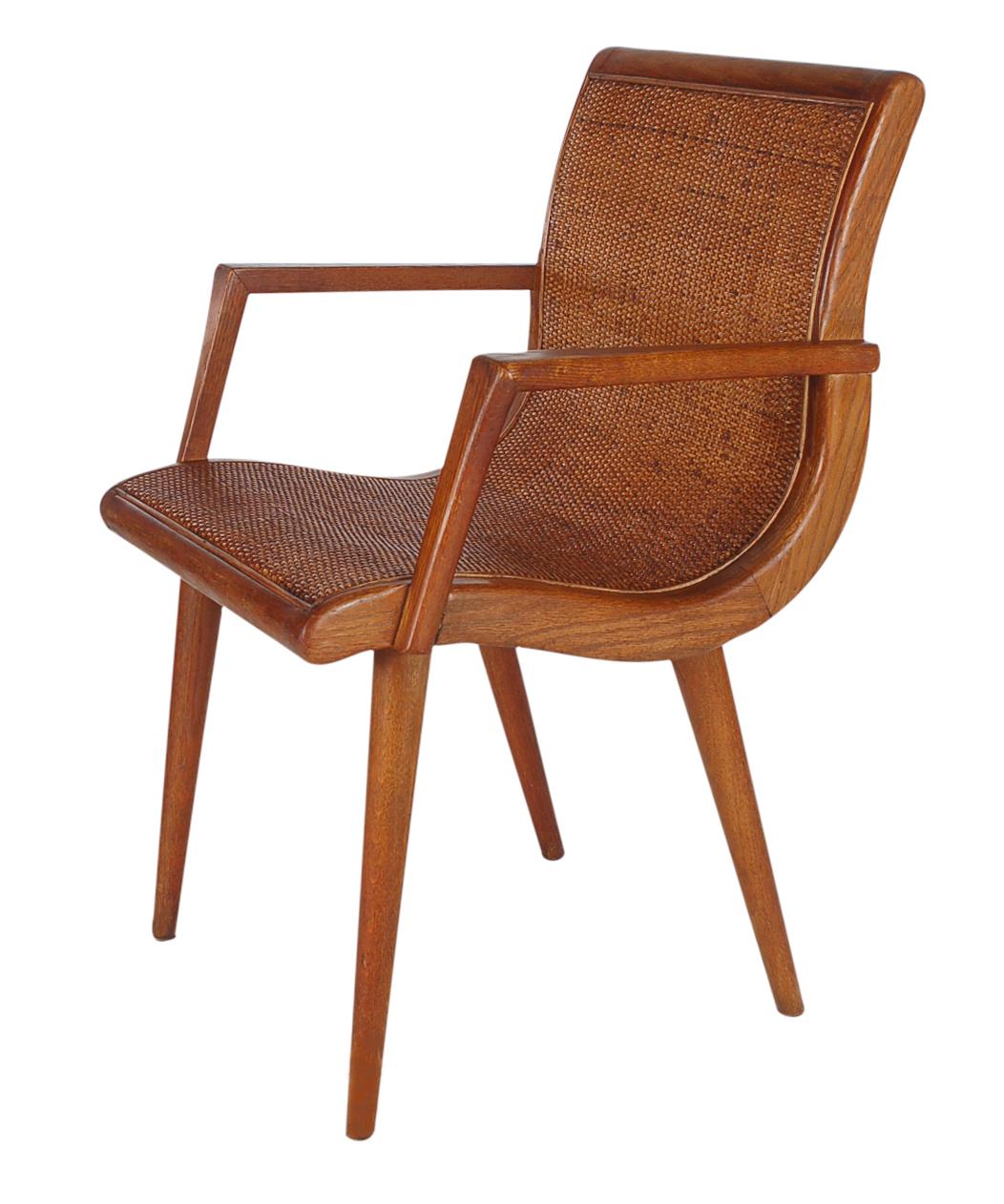 A very handsome armchair from the 1960s. It features solid oak framing with full cane seat and back rests.
 