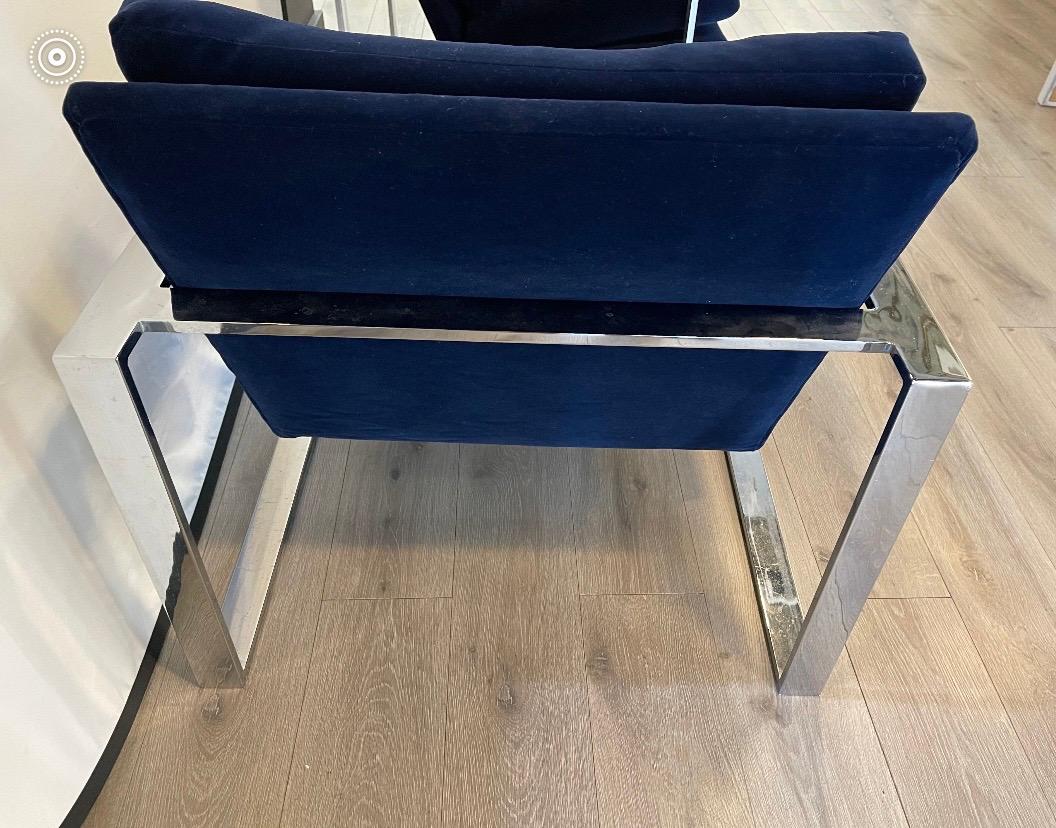 Iconic pair of chrome and steel cantilever chairs done in a newer navy blue velvet upholstery.
All dimensions are below except seat depth which is 18