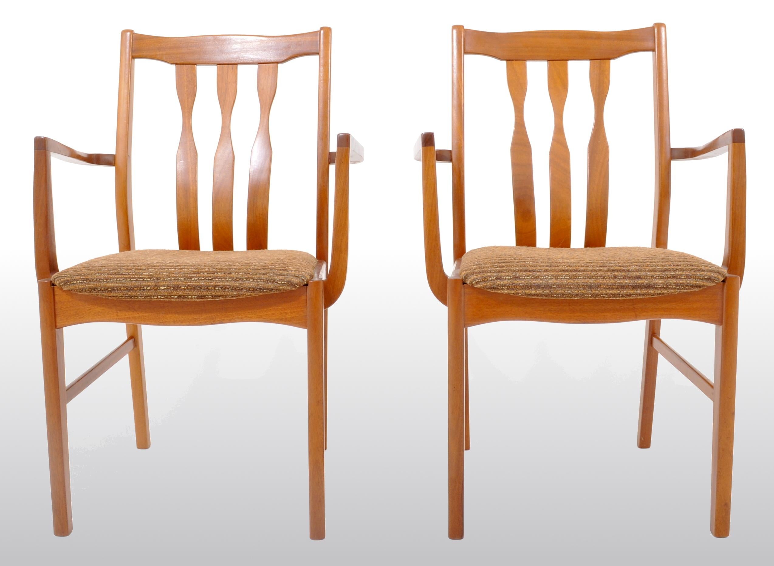 Pair of Mid-Century Modern captain's/armchairs in teak, 1960s. The chairs having three backsplats and shaped arms, having the original textured mohair fabric.