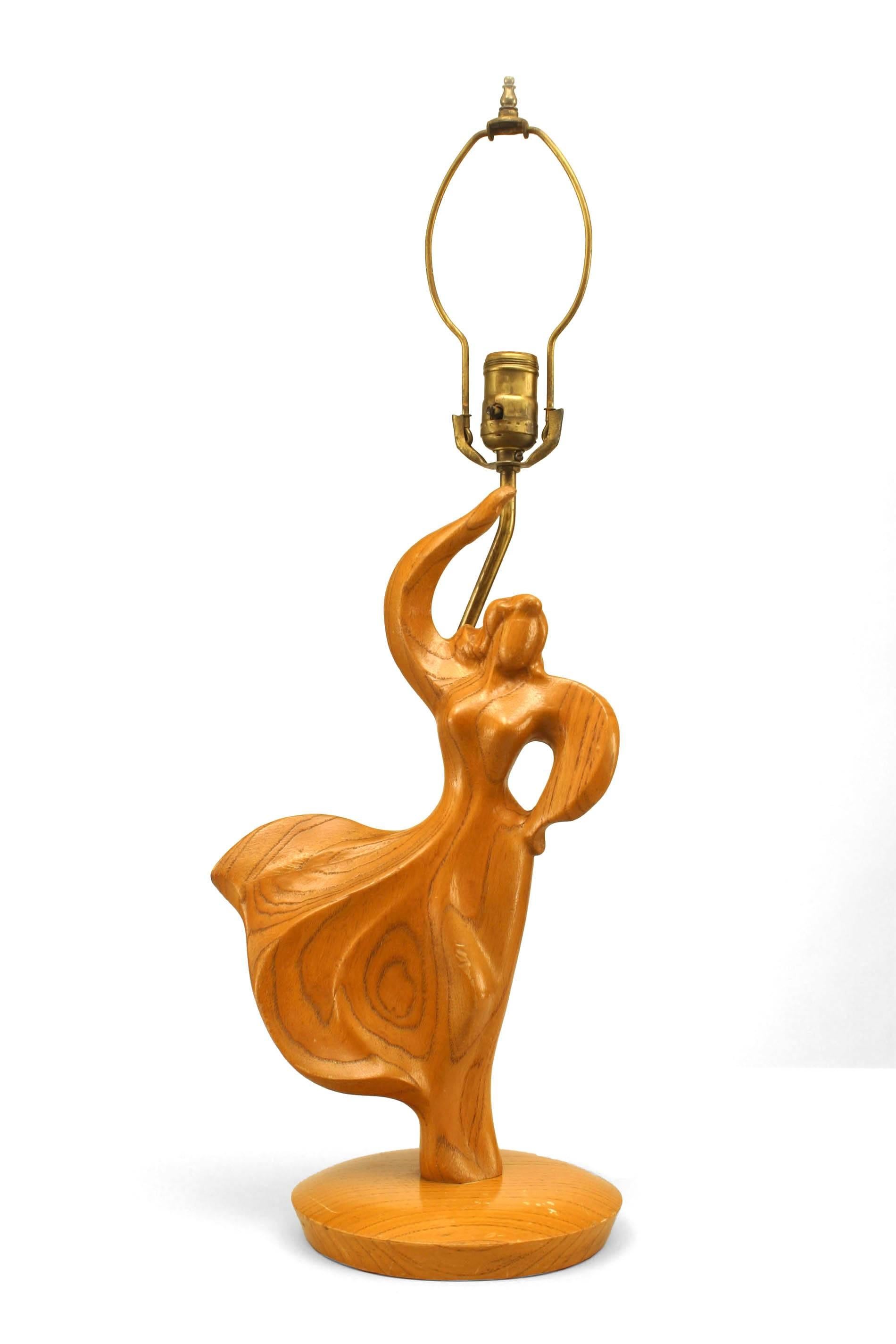 Pair of Mid-century modern carved fruitwood lamps in the form of a stylized dancing male and female on round bases (attributed to HEIFETZ) (PRICED AS Pair).
