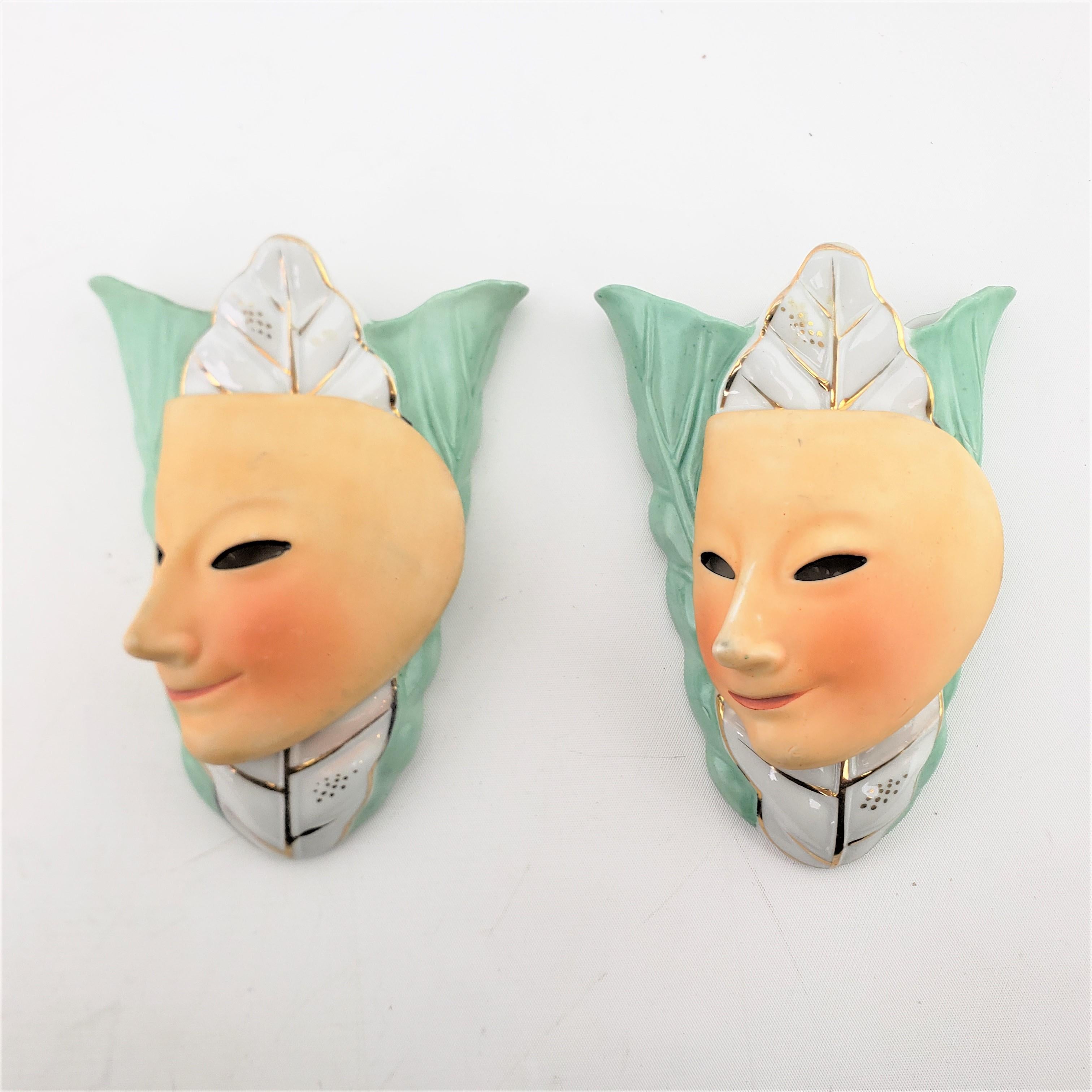 This pair of wall pockets are sculptures are marked by an unknown maker, but originated from Japan and date to approximately 1940 and done in the period Mid-Century Modern style. The wall pockets or sculptures are made of ceramic and depict stylized