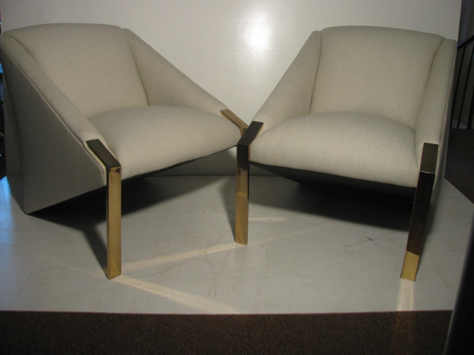Rare pair of exceptional sculpted lounge chairs. Angular, sleek and sexy pair of very comfortable lounge chairs. Heavy duty frames which were newly reupholstered in a simple tweed fabric which is a light beige in color. Chrome legs upfront. 