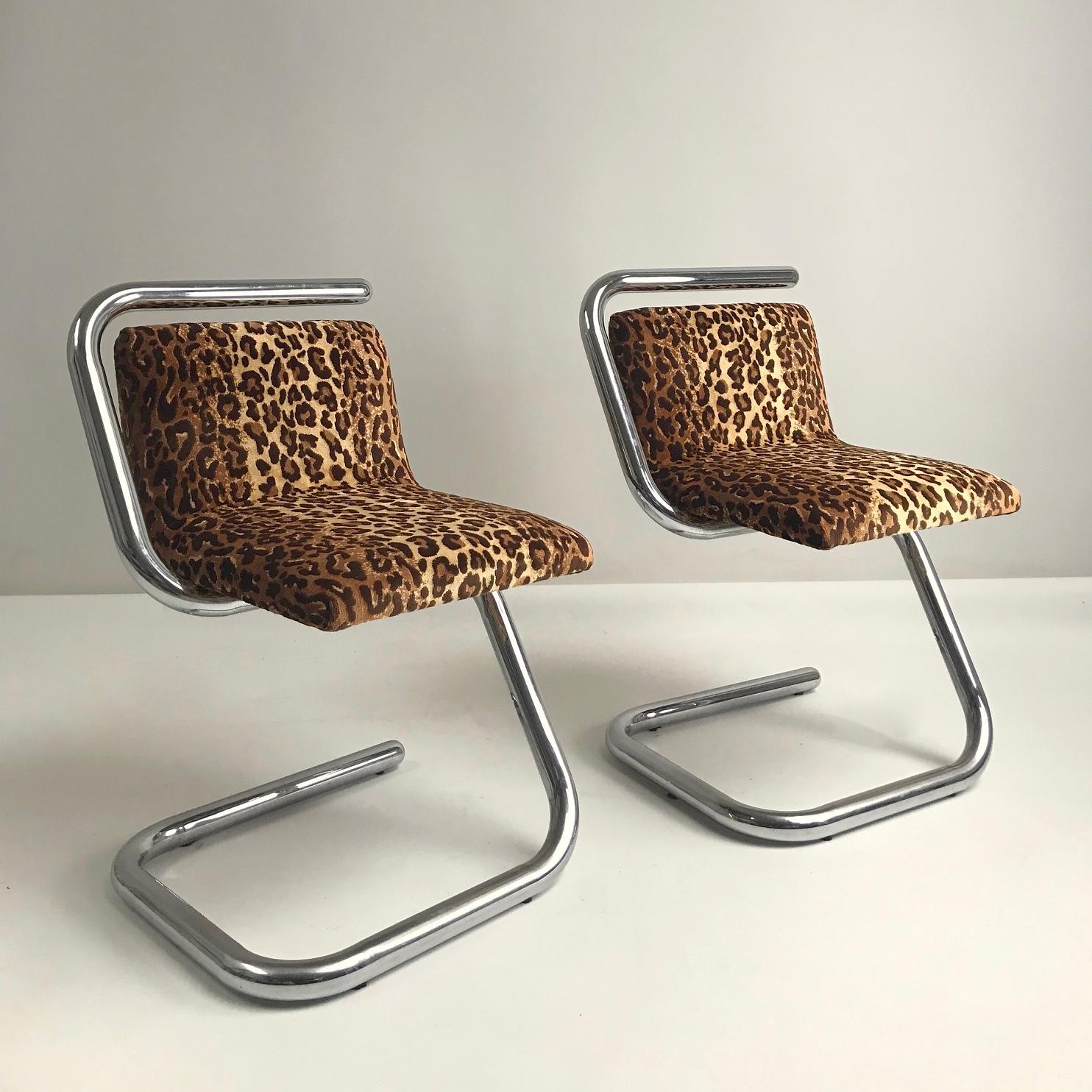 Unusual pair of mid-century chairs, circa 1970, France.
Chromed metal tubular structure, winding from the base to the back through the seating. 
The seat and back covered with leopard pattern fabric.
Dimensions: 74 cm H, 46 cm W, 48 cm D, seat